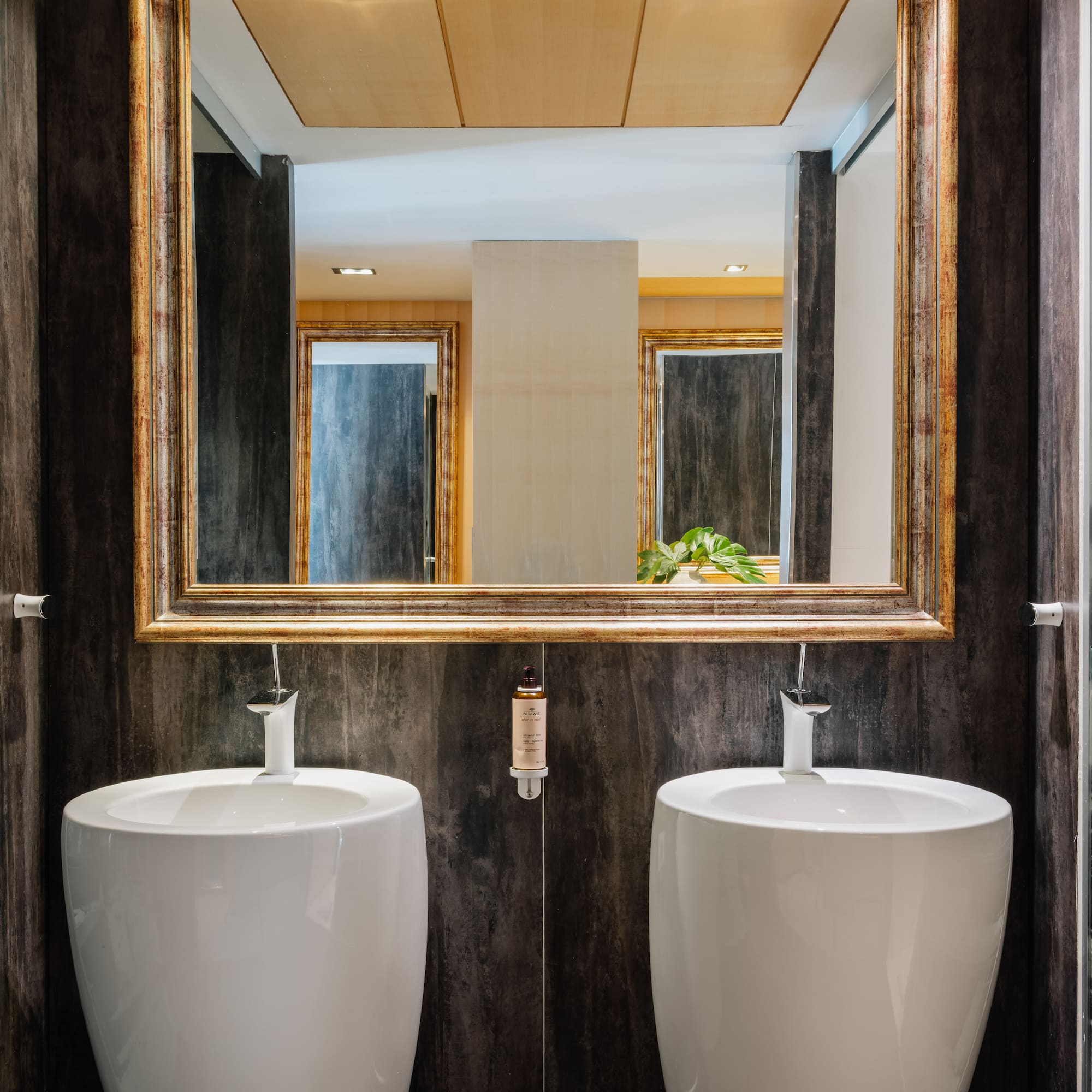 a bathroom with two sinks and a mirror