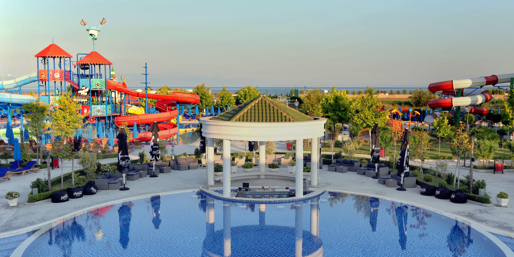 a pool with a gazebo and a playground