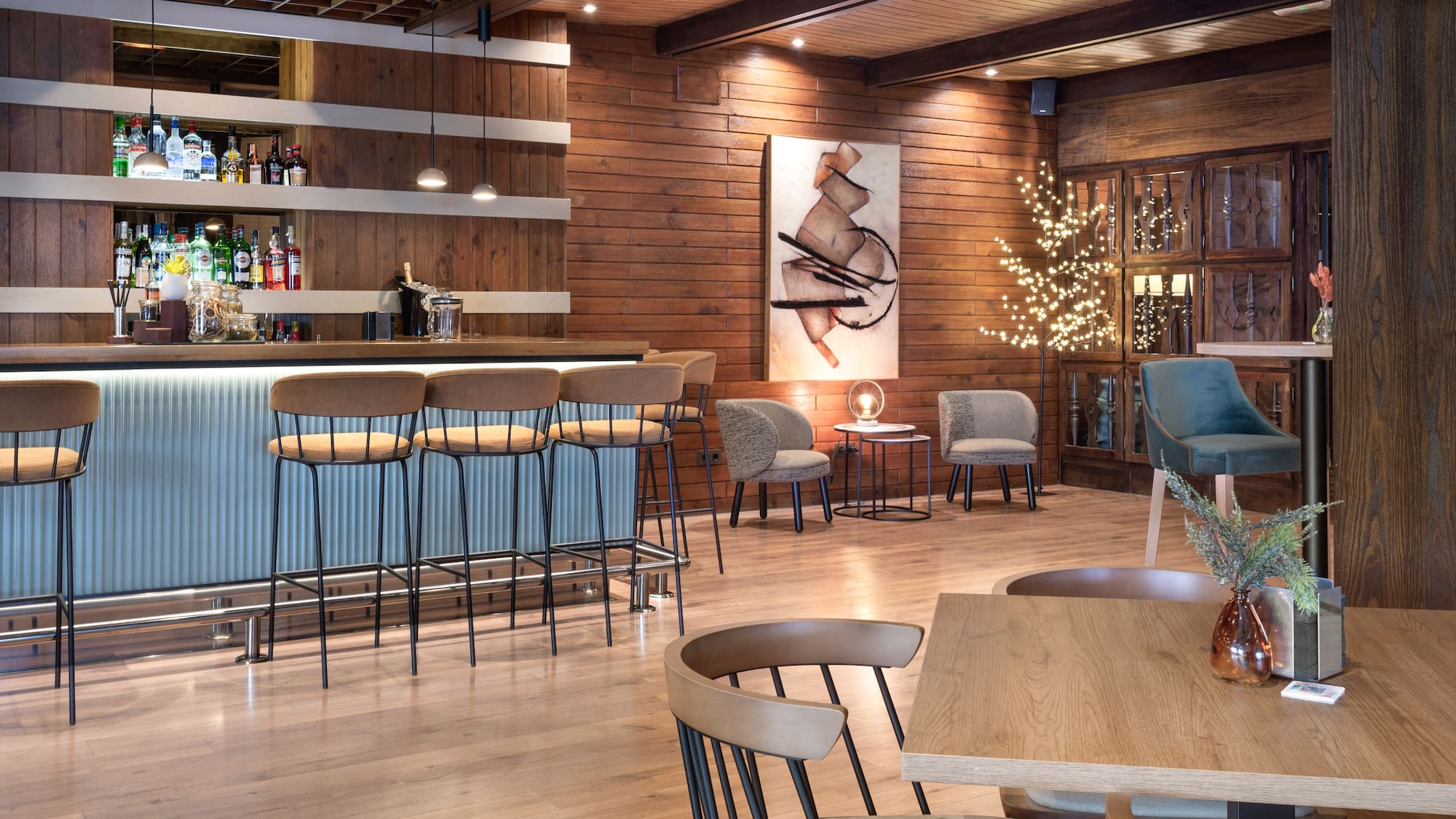 a room with a bar and chairs