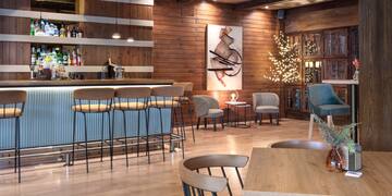 a room with a bar and chairs