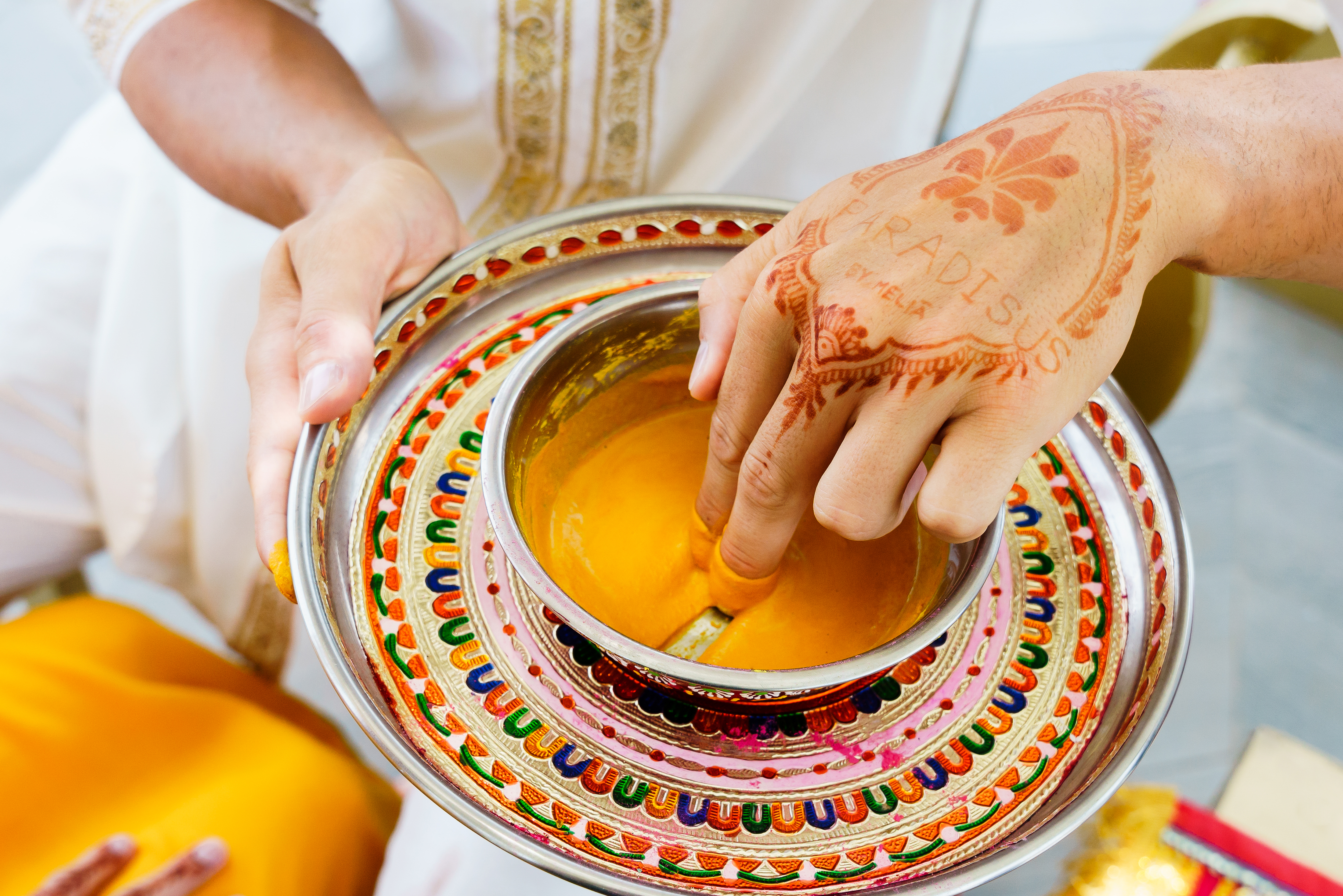 a person holding a bowl of liquid