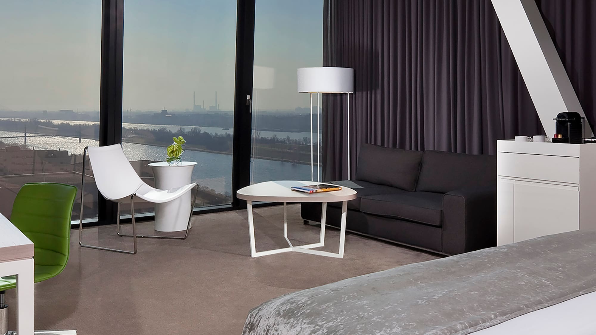 a room with a large window and a bed and a table