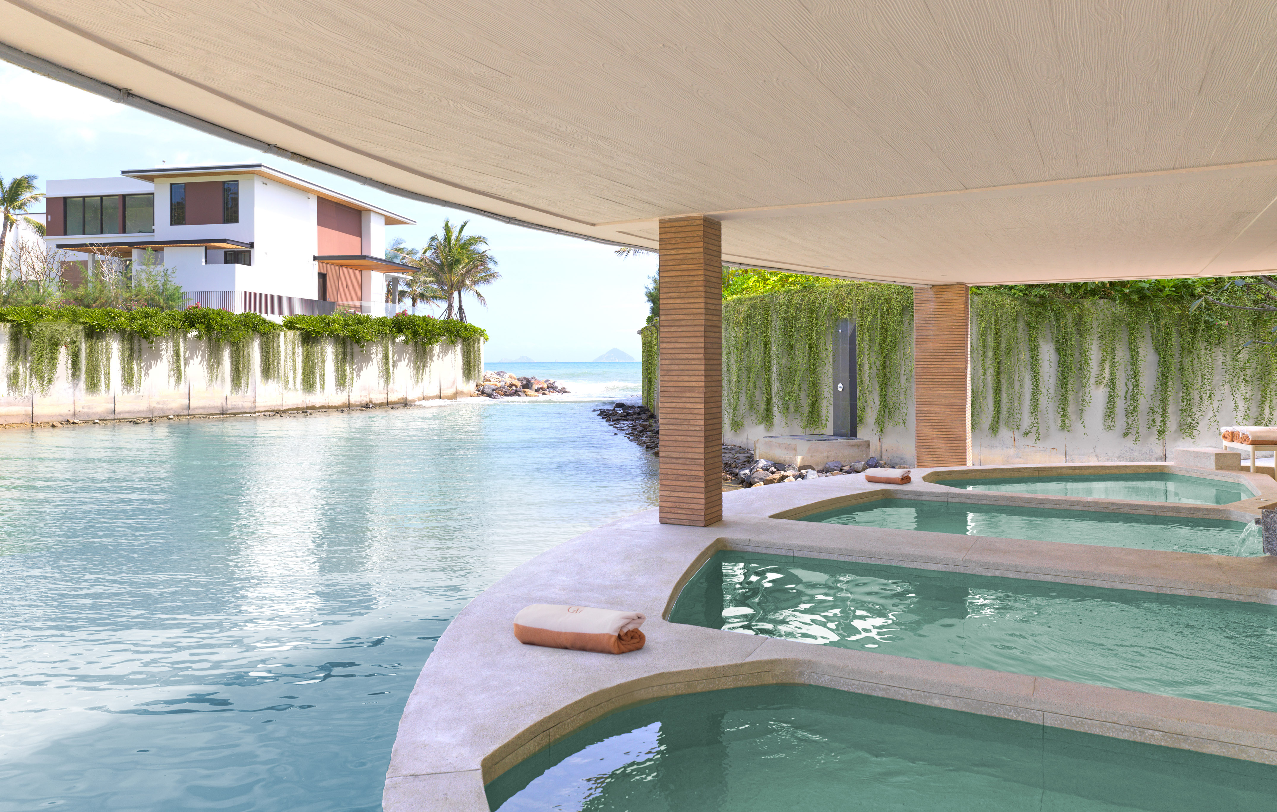 Luxury resort spa with ocean view hot tubs, villa, and tropical lagoon.