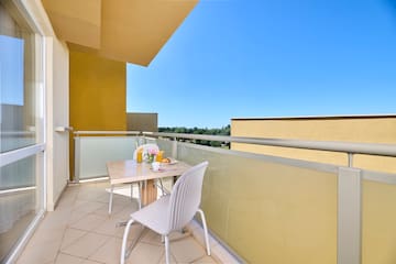 a table and chair on a balcony
