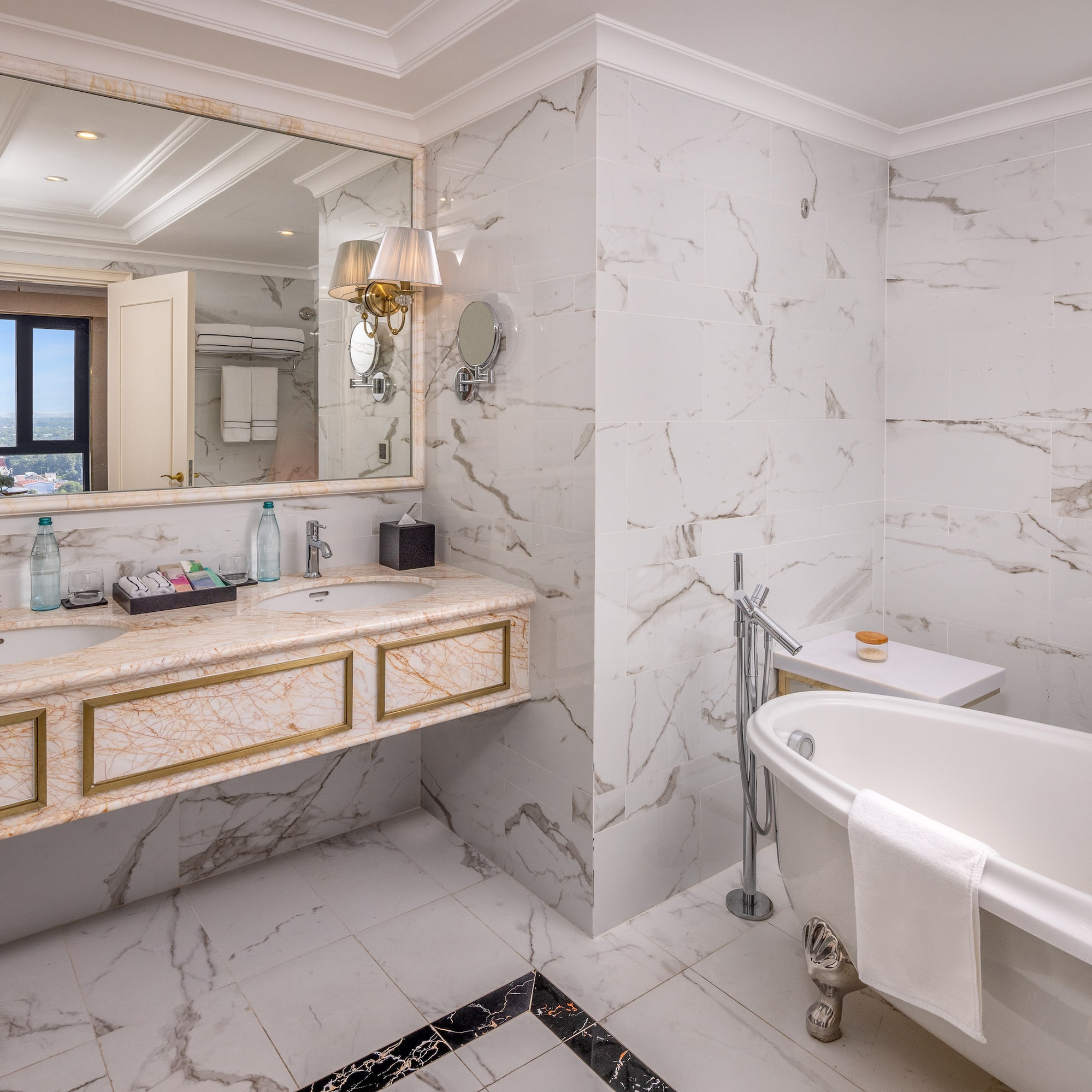 a bathroom with marble walls and a tub