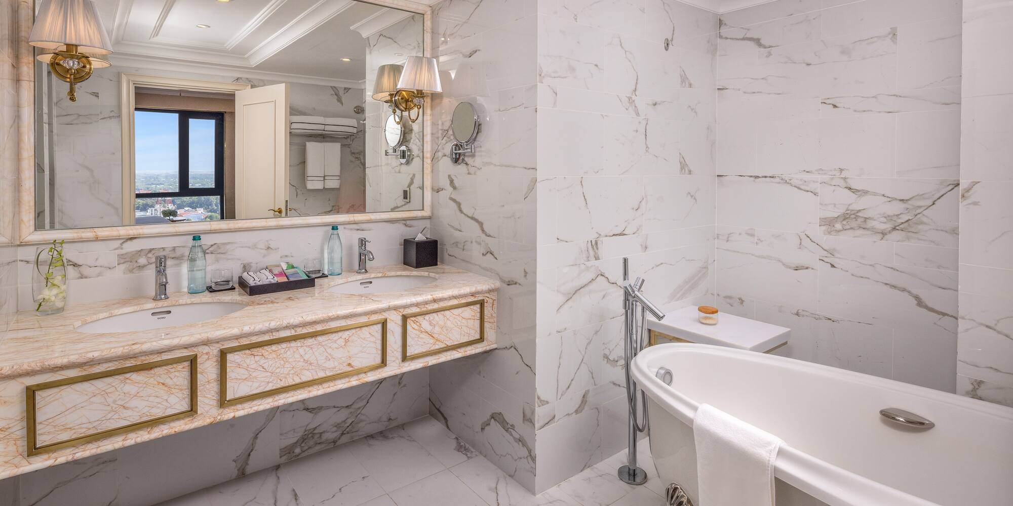 a bathroom with marble walls and a tub
