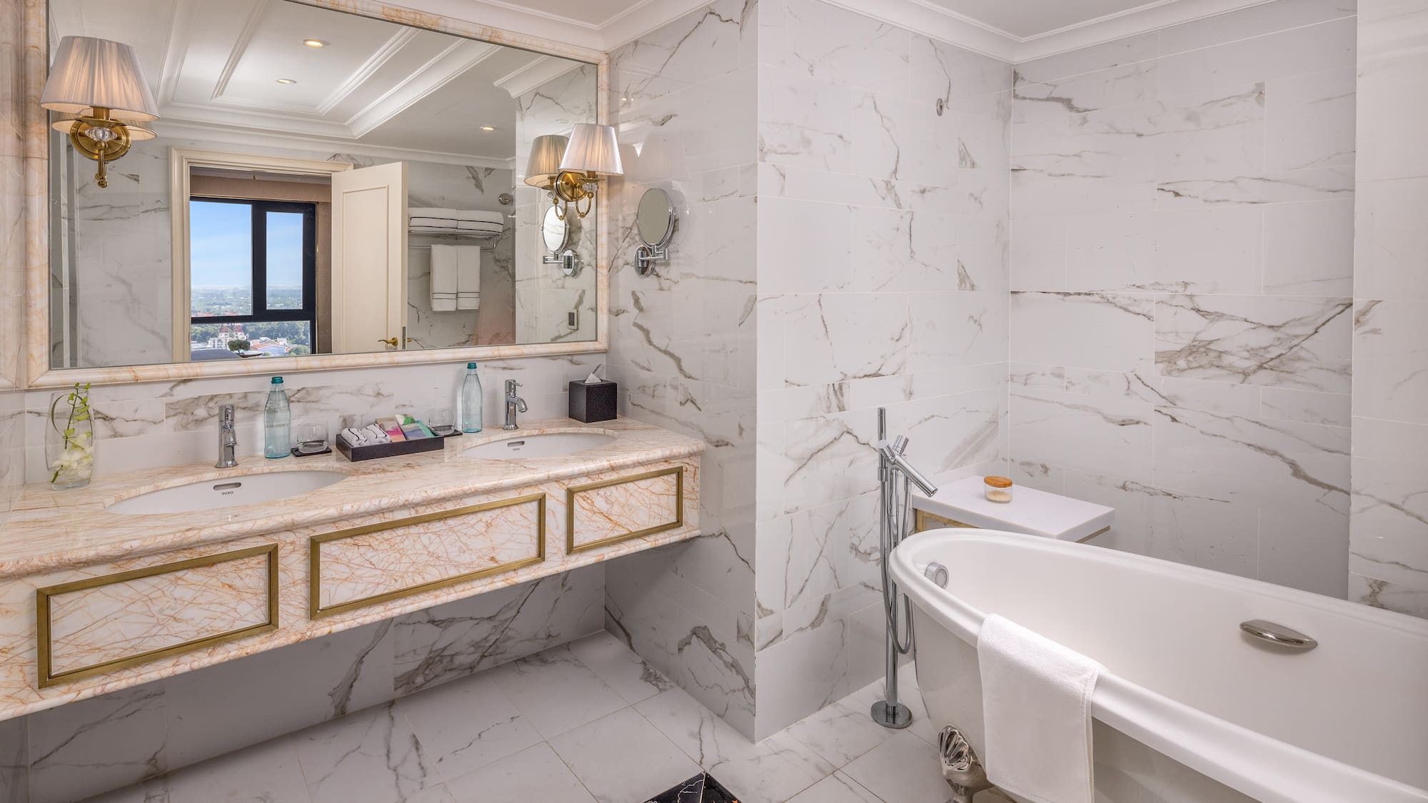 a bathroom with marble walls and a tub