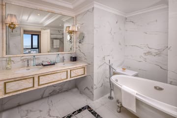 a bathroom with marble walls and a tub
