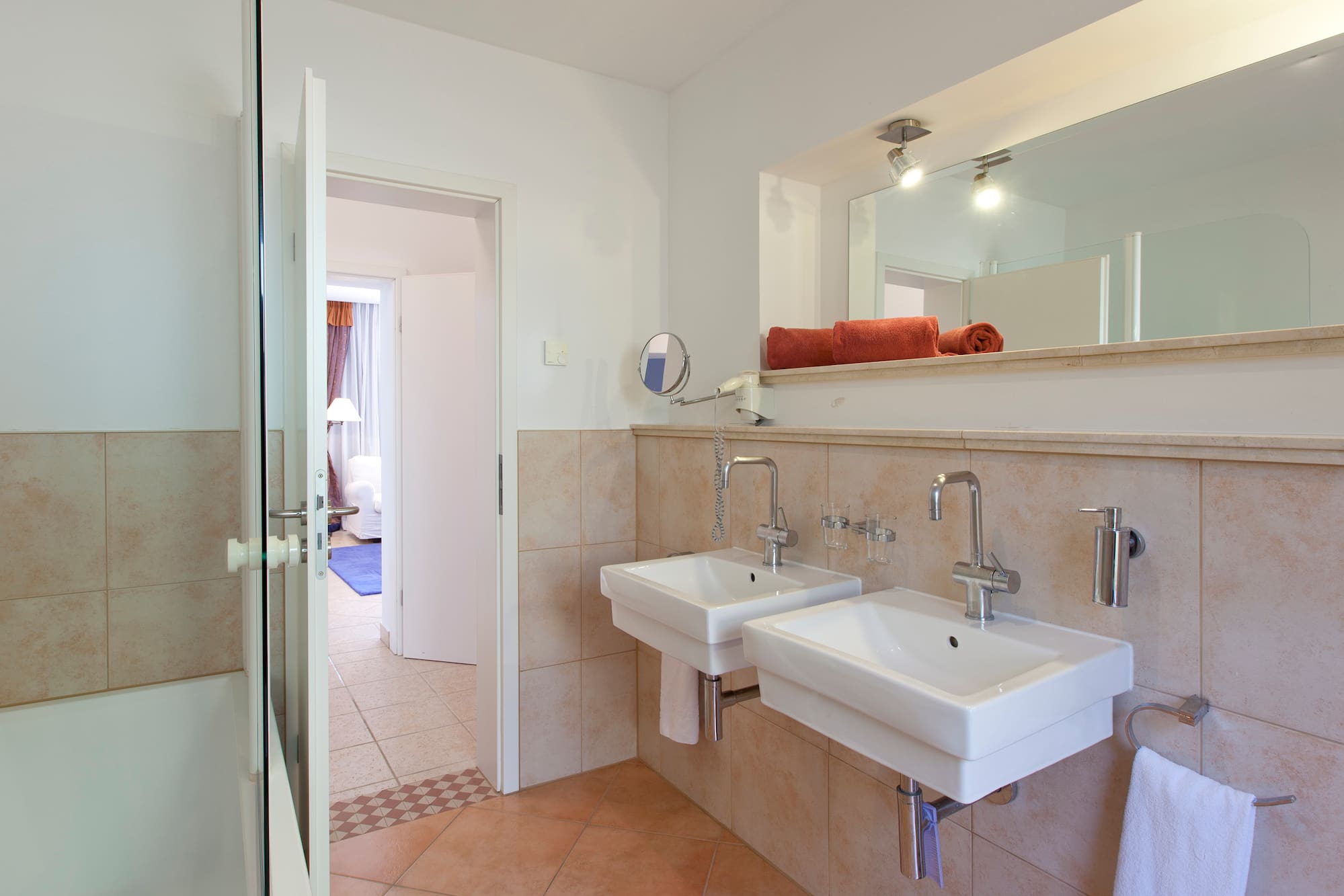 a bathroom with two sinks and a mirror