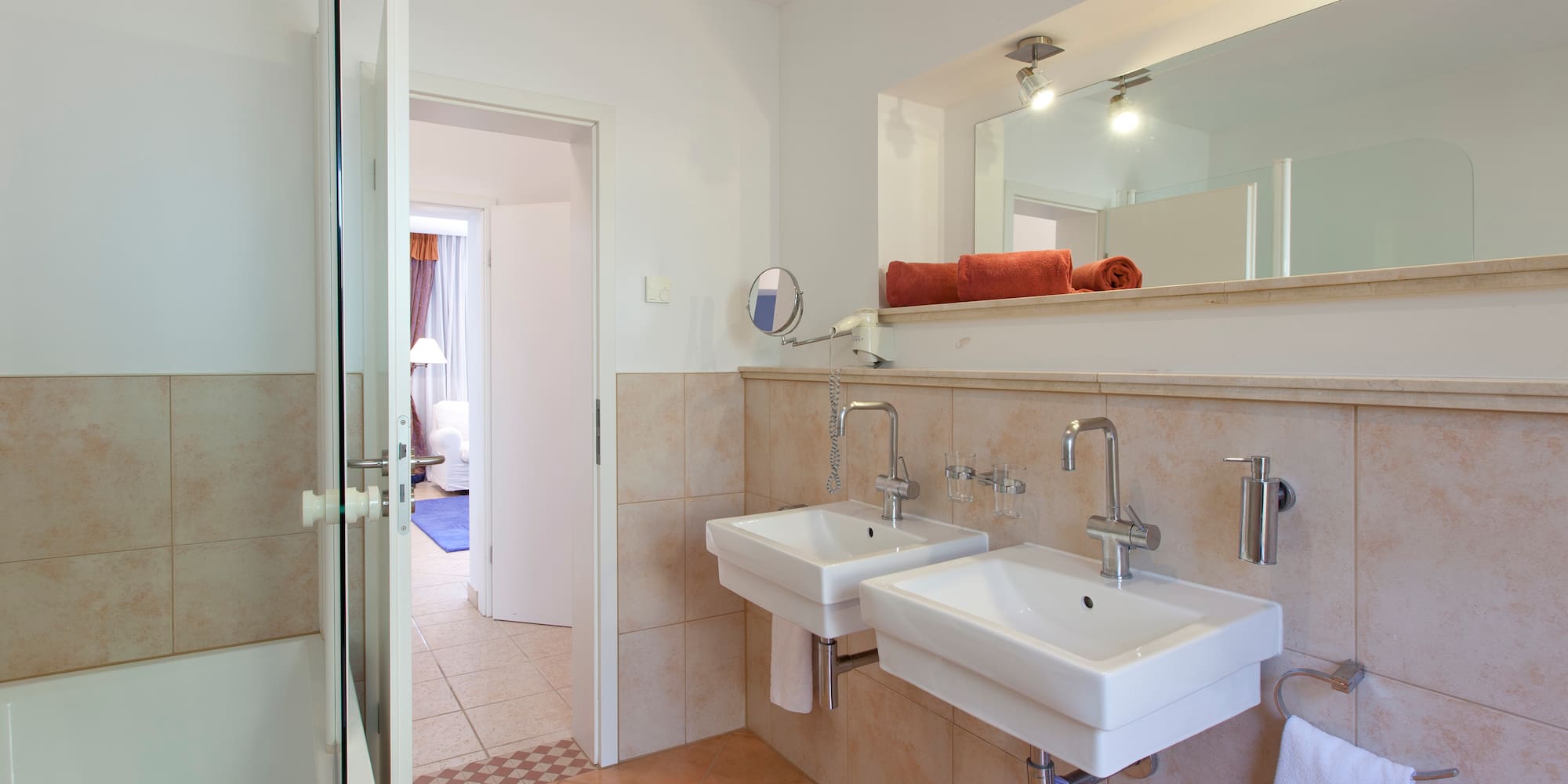 a bathroom with two sinks and a mirror