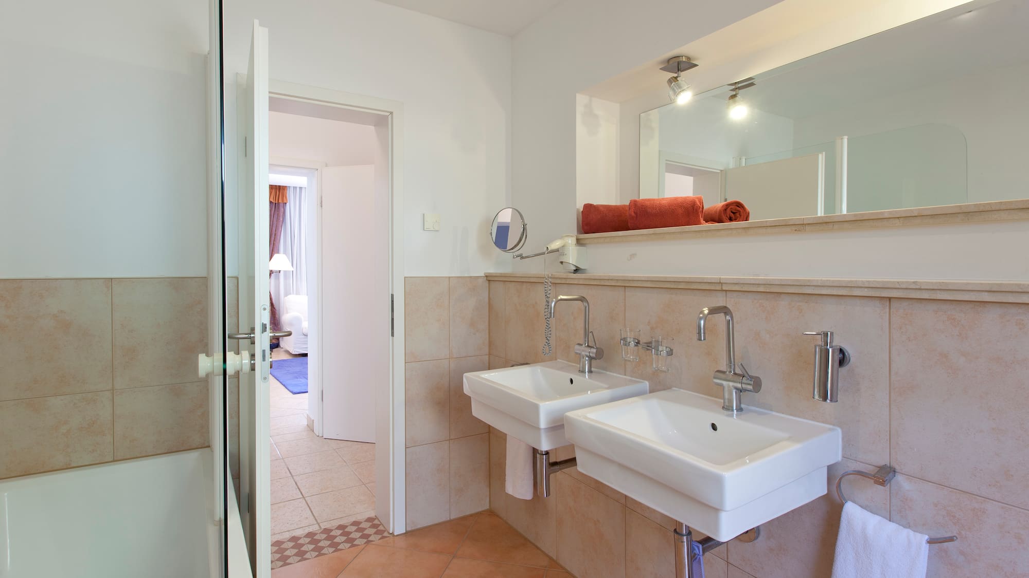 a bathroom with two sinks and a mirror