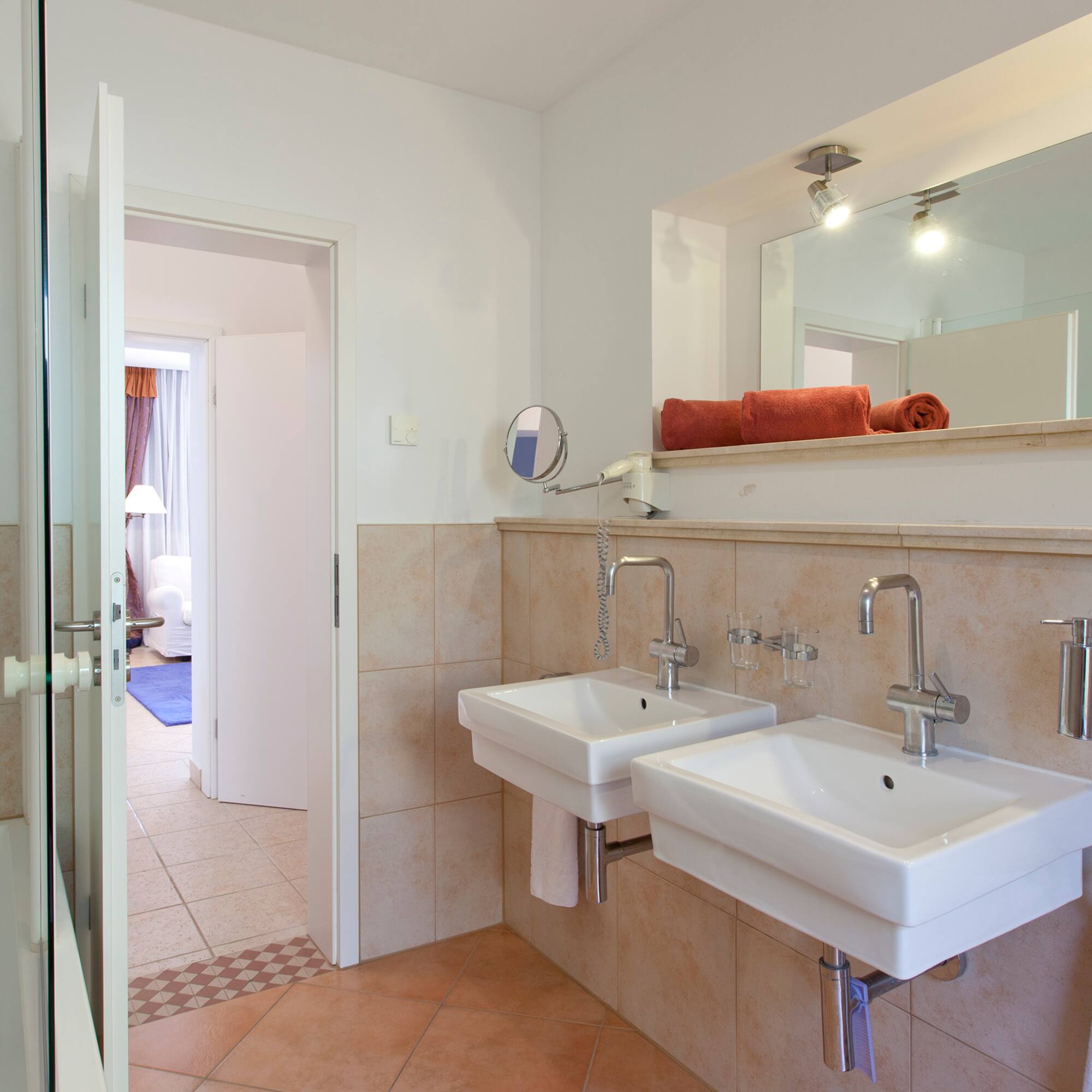 a bathroom with two sinks and a mirror
