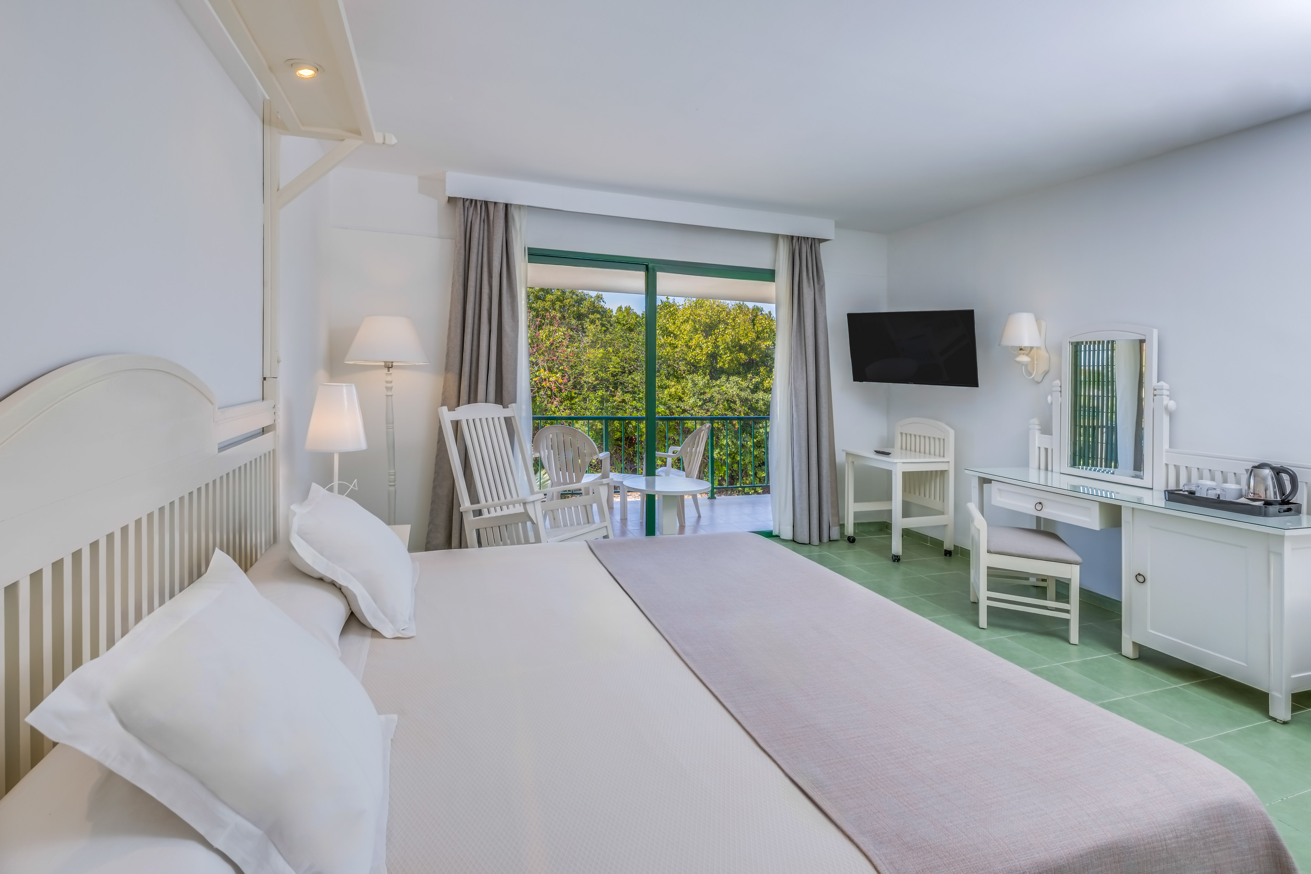 a bedroom with a large bed and a television.