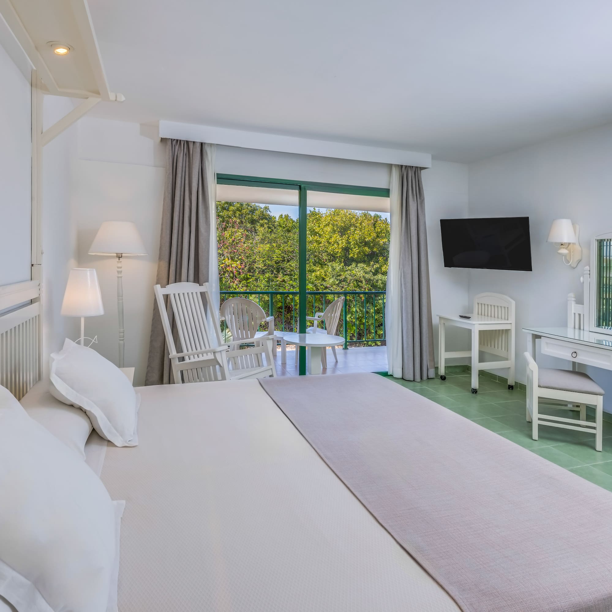 a bedroom with a large bed and a television.