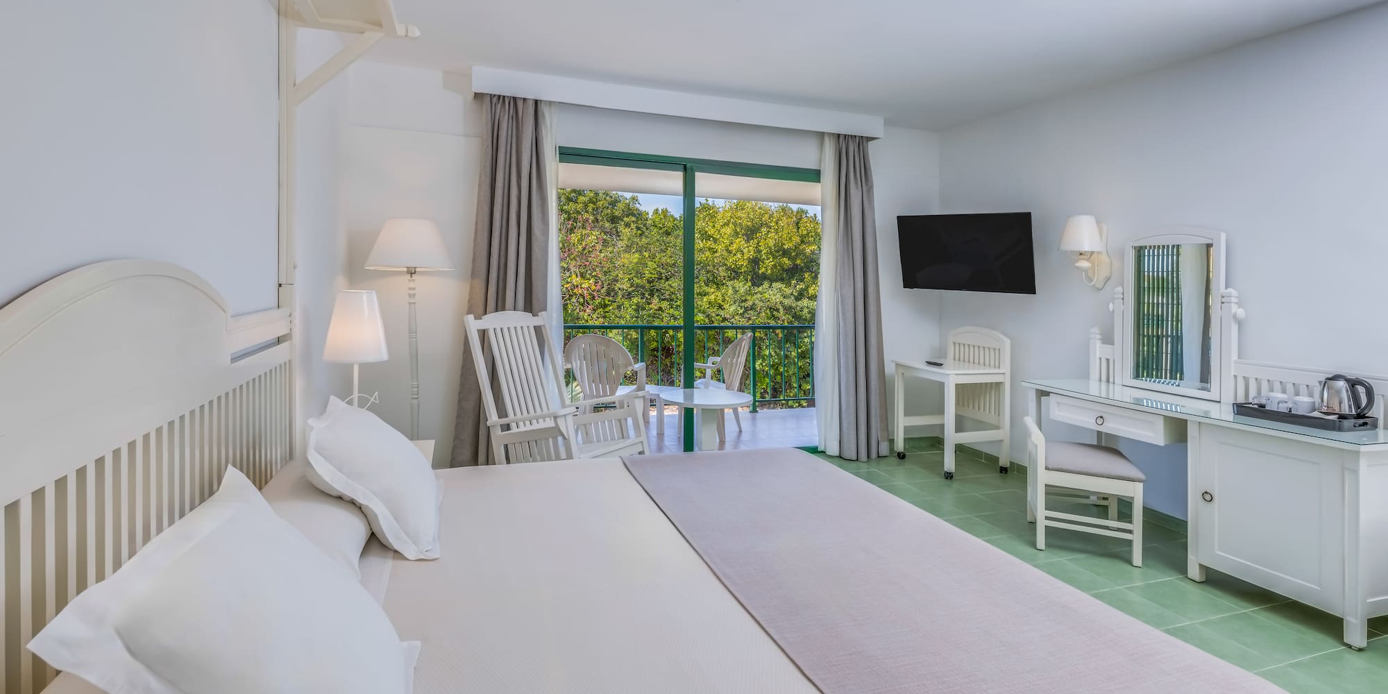 a bedroom with a large bed and a television.