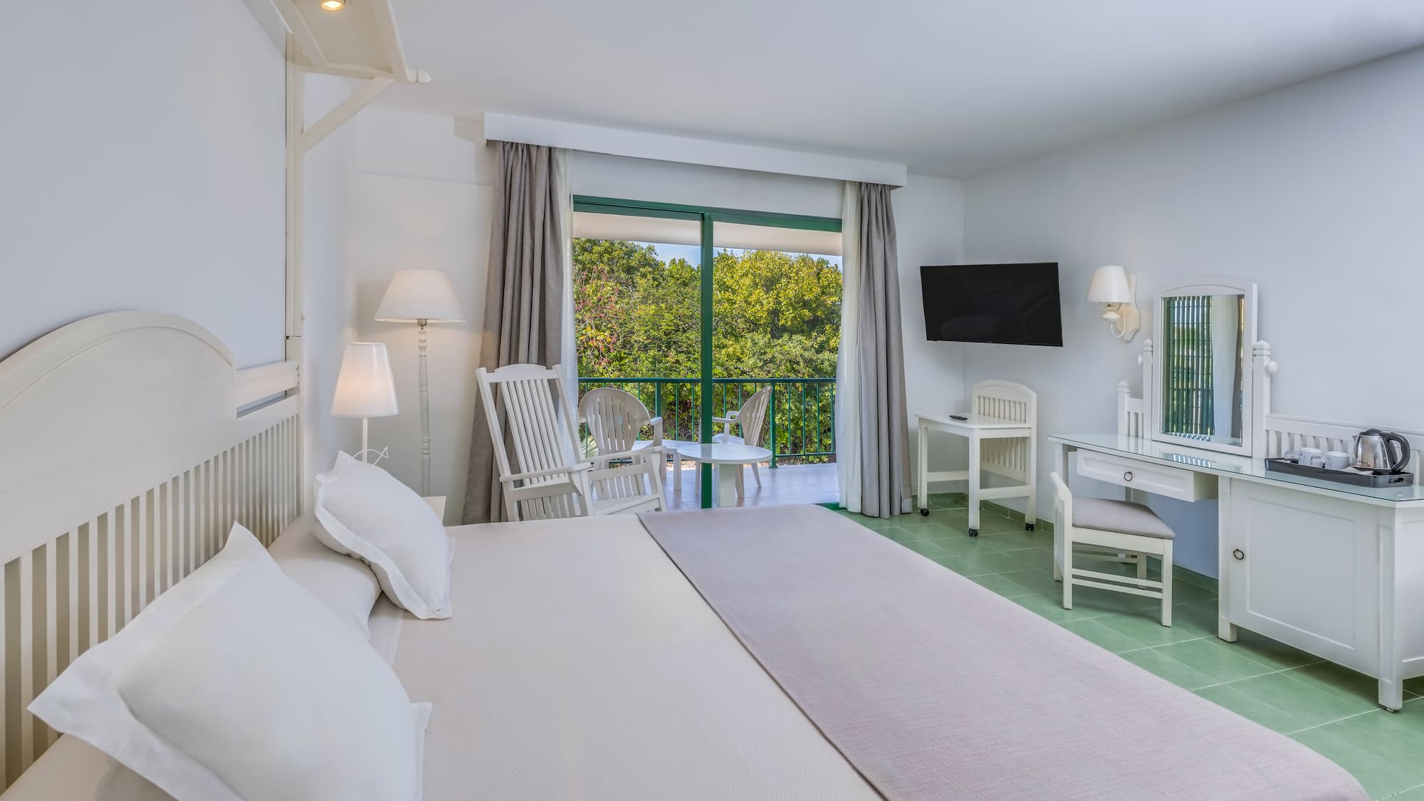 a bedroom with a large bed and a television.