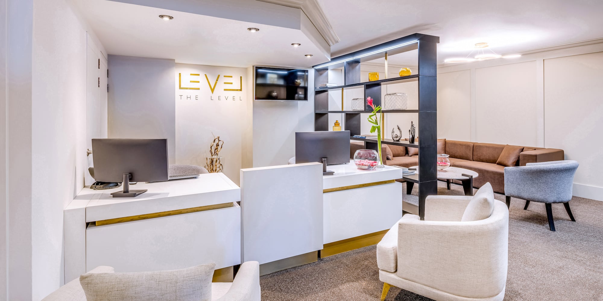 a room with a computer desk and chairs