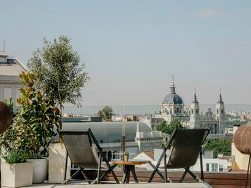 chairs on a rooftop overlooking a city