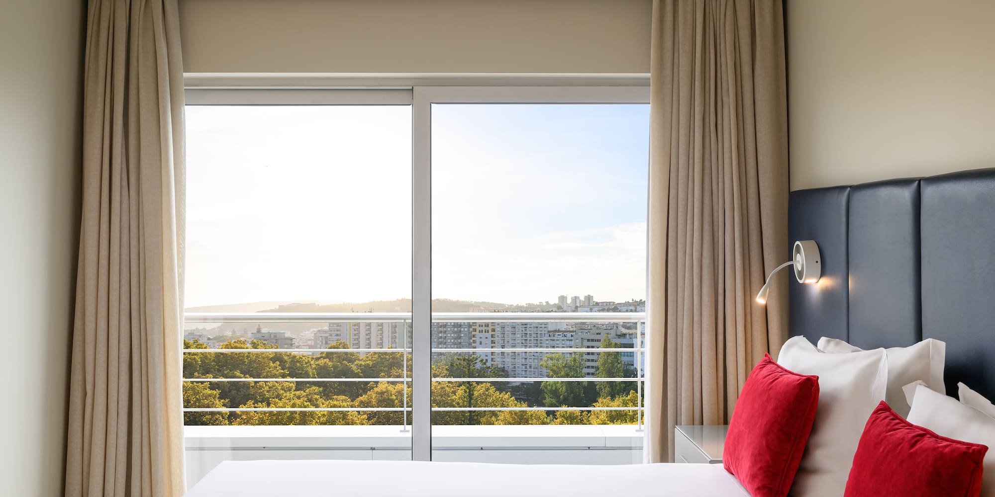 a bed with a window and a view of the city