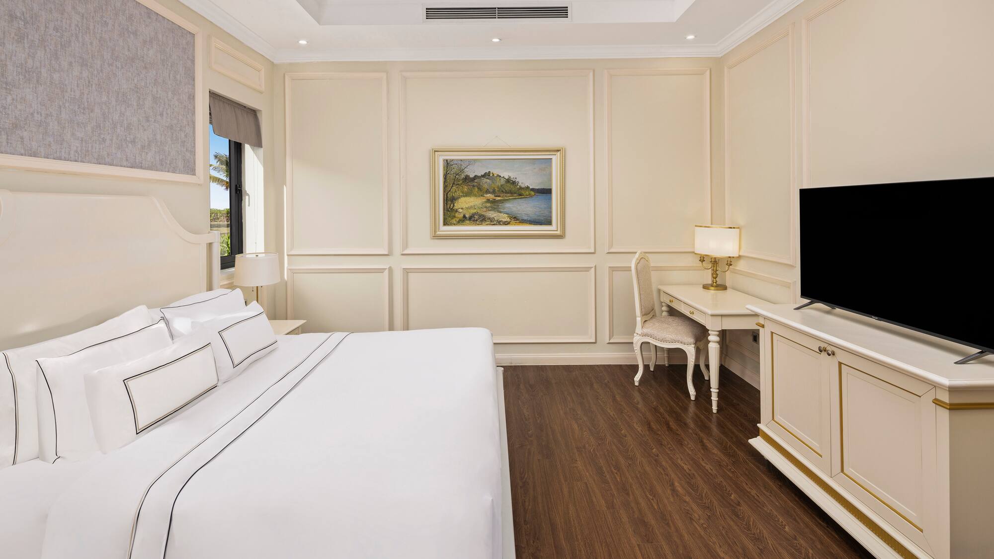 a bedroom with a bed and a television