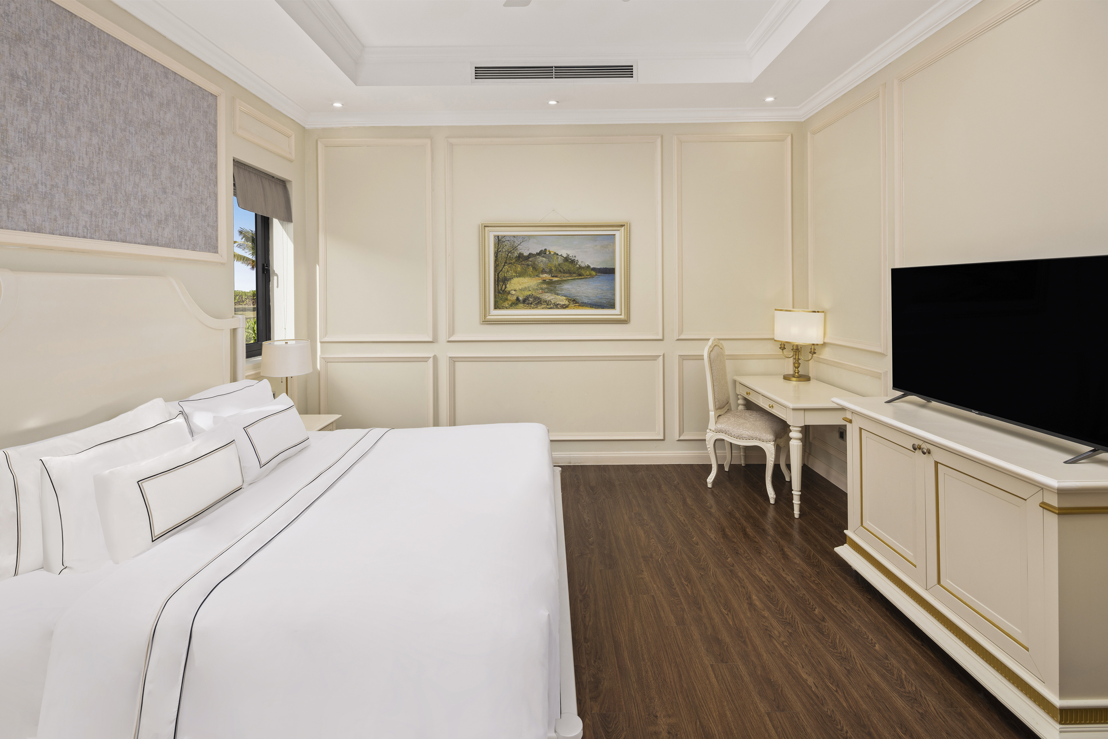 a bedroom with a bed and a television