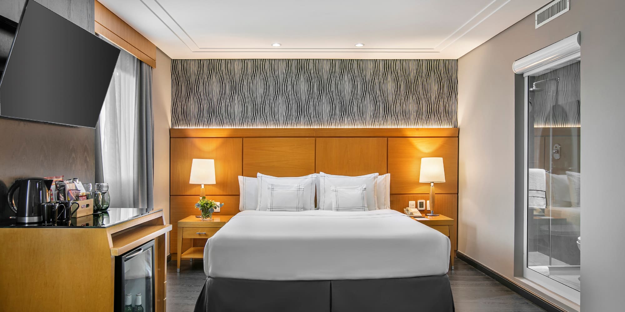 a room with a bed and a television