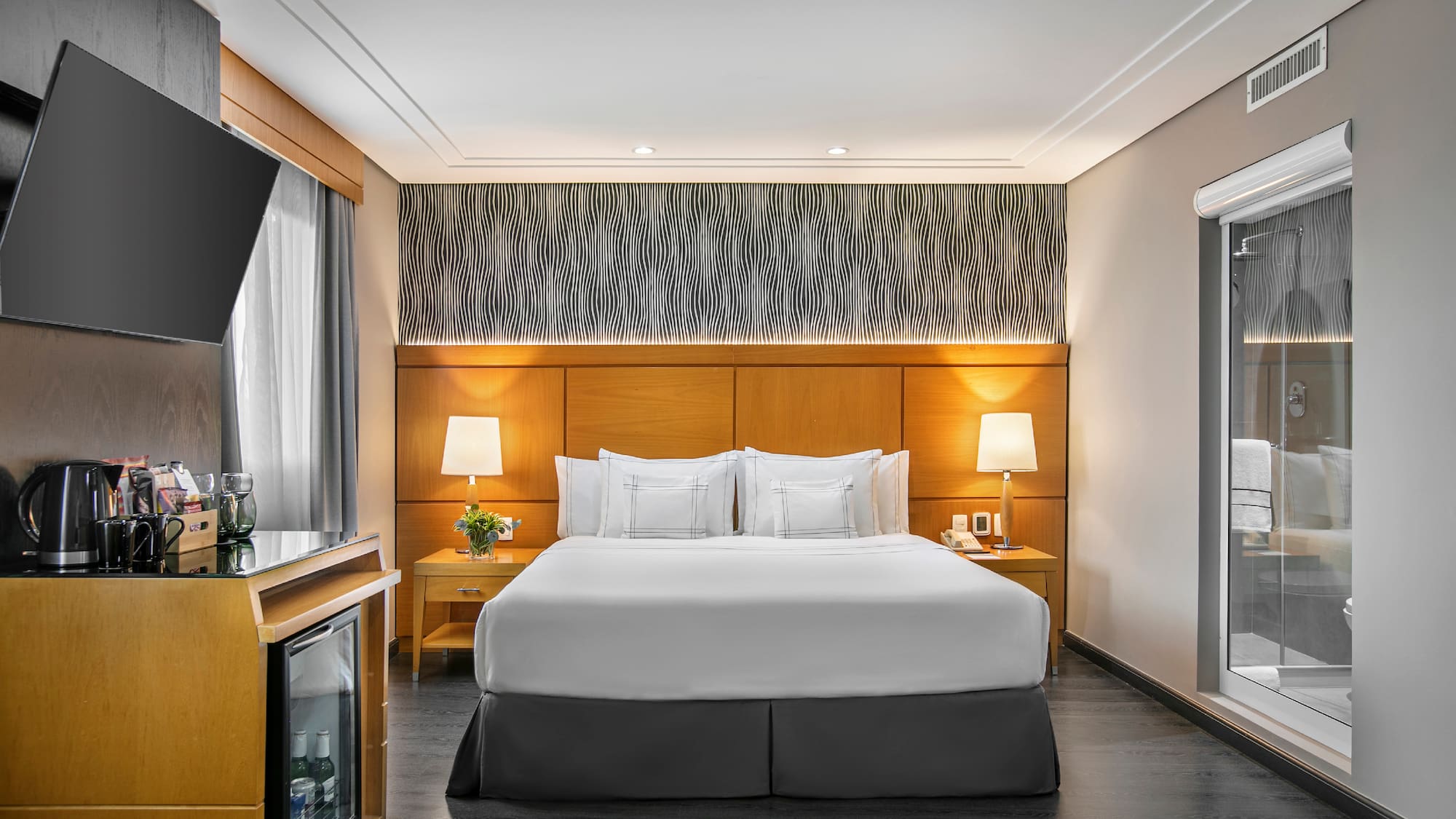 a room with a bed and a television