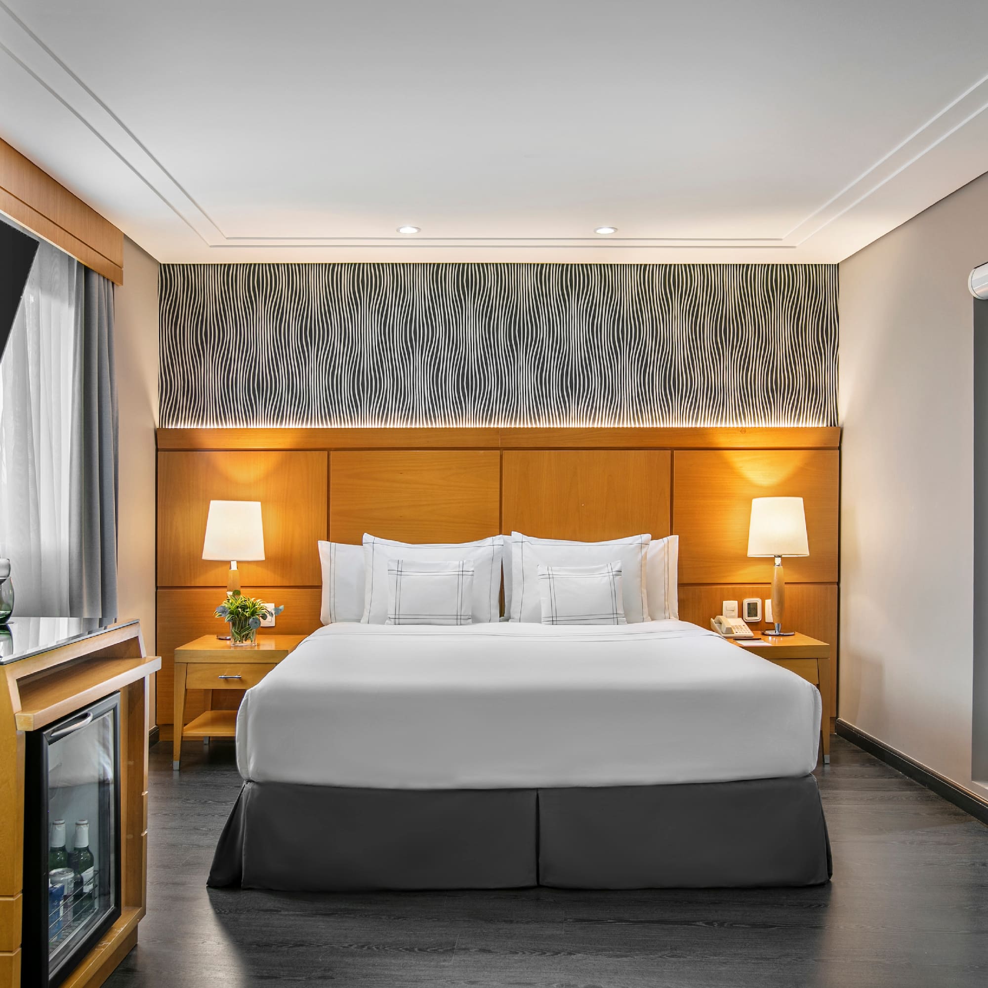 a room with a bed and a television