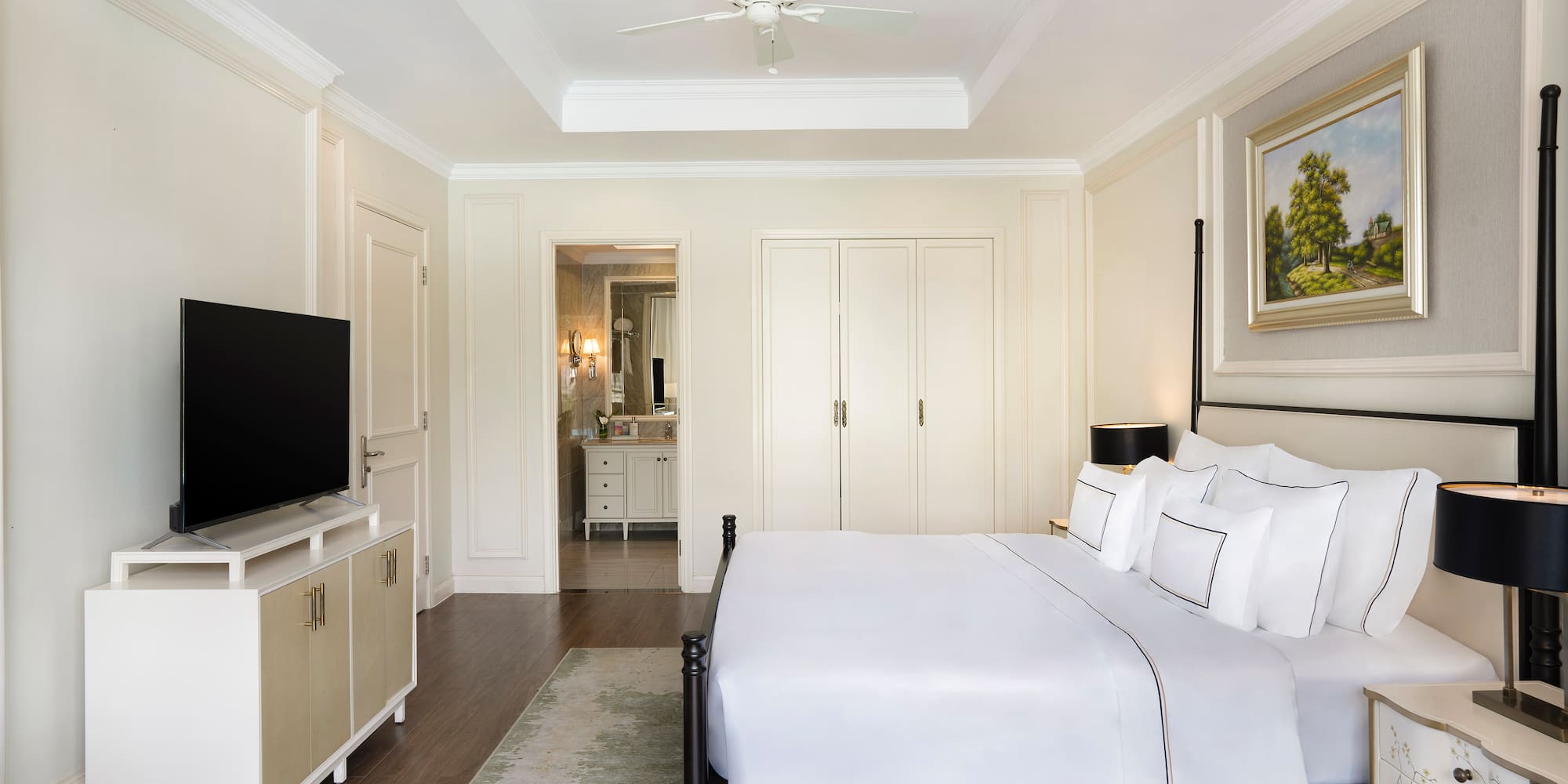 a bedroom with a bed and a television