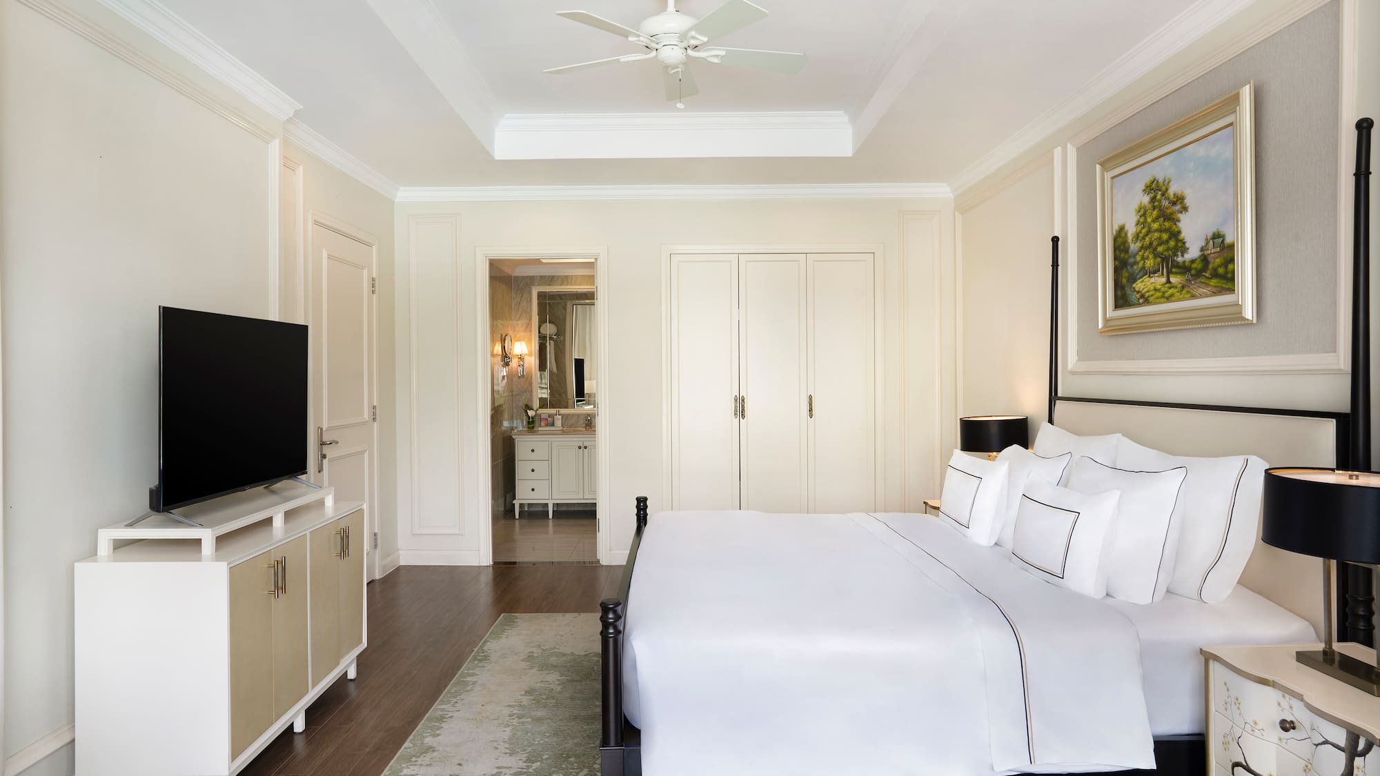 a bedroom with a bed and a television