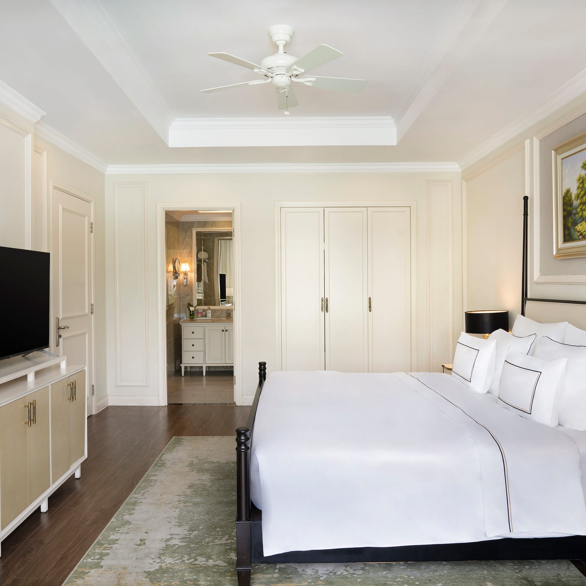 a bedroom with a bed and a television