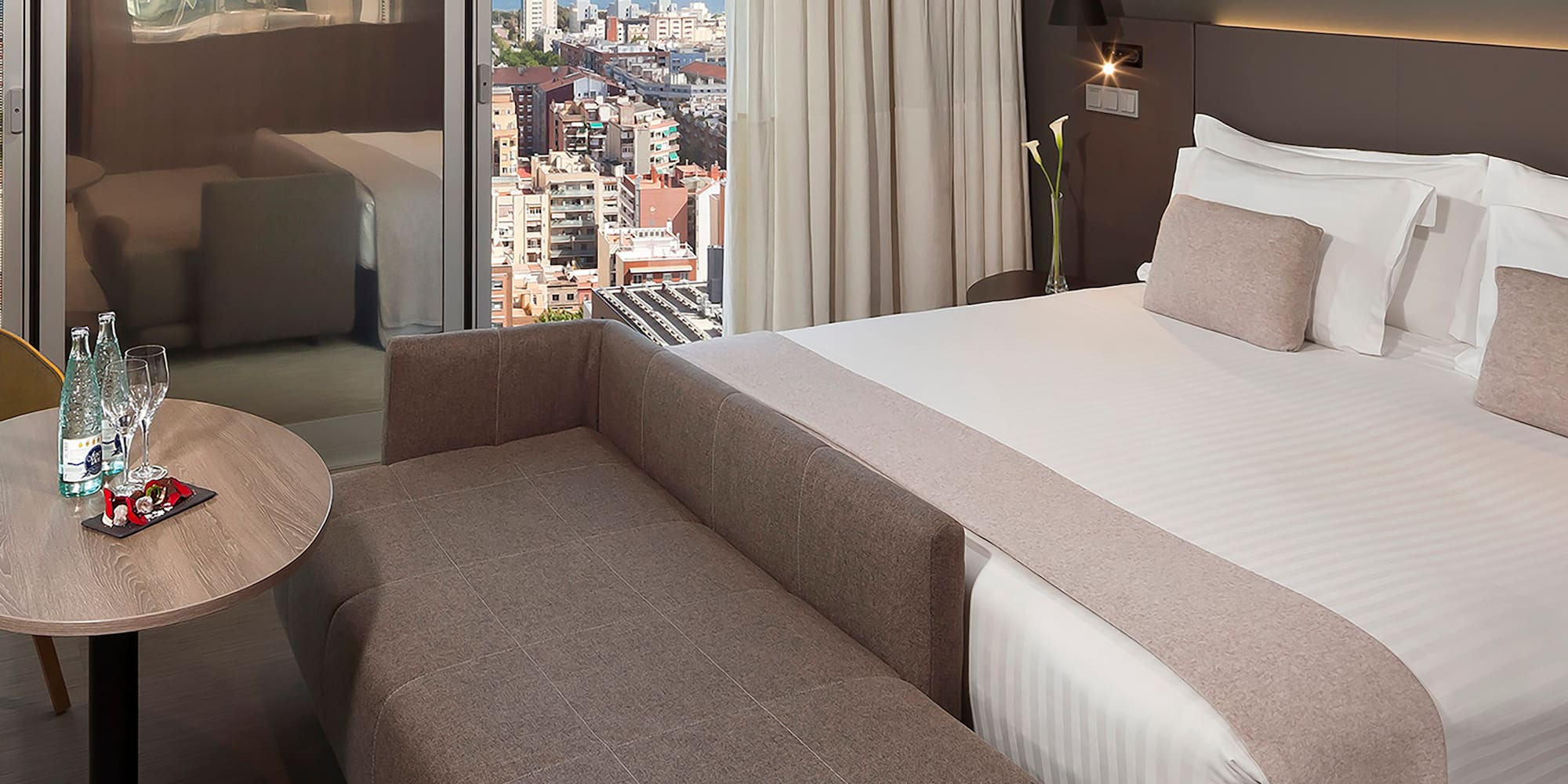 a room with a bed and a table and a window