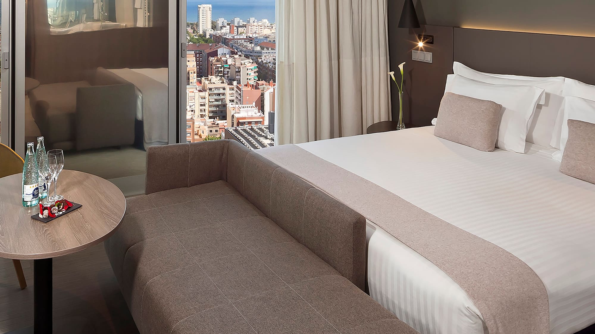 a room with a bed and a table and a window