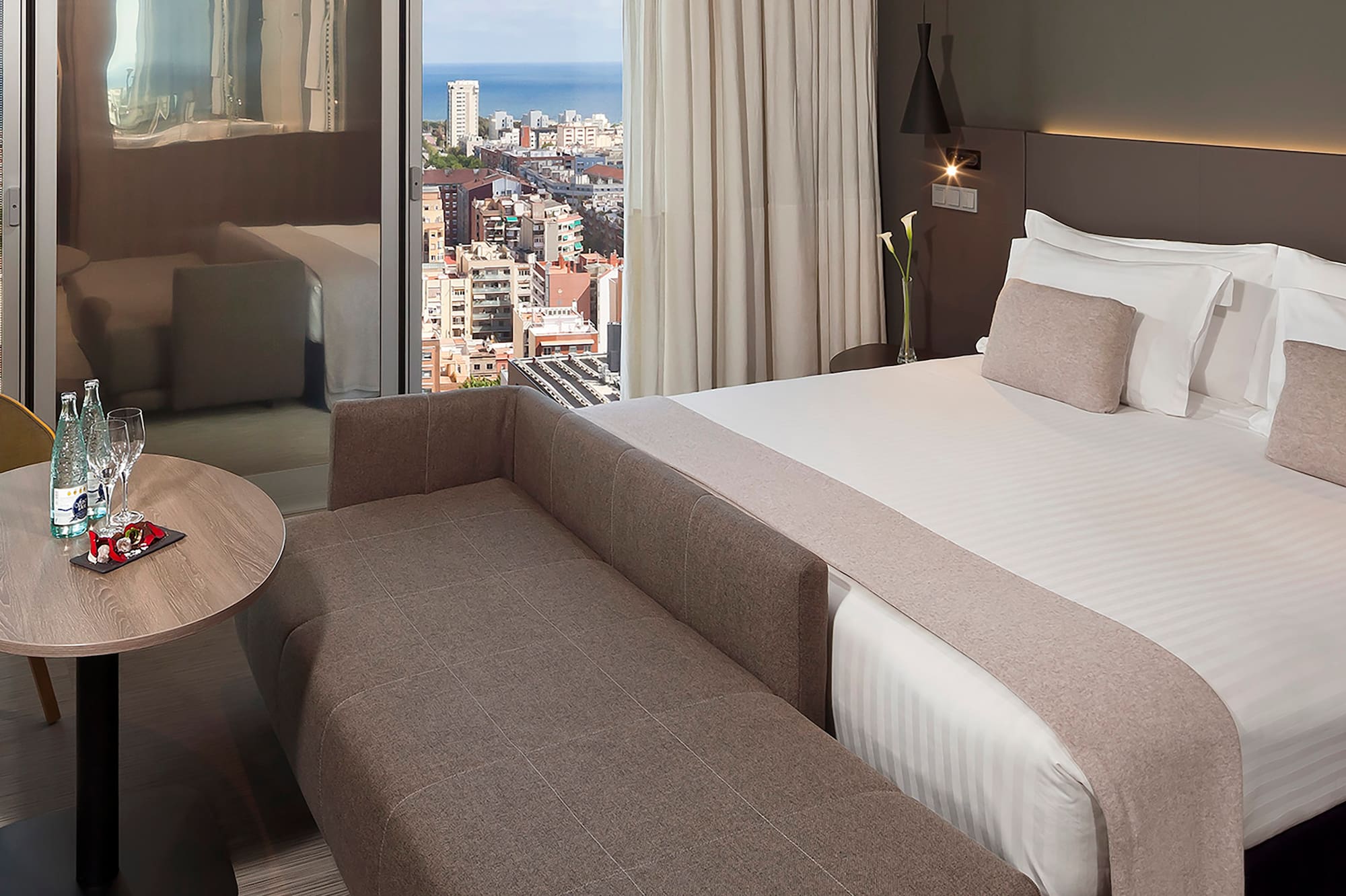 a room with a bed and a table and a window