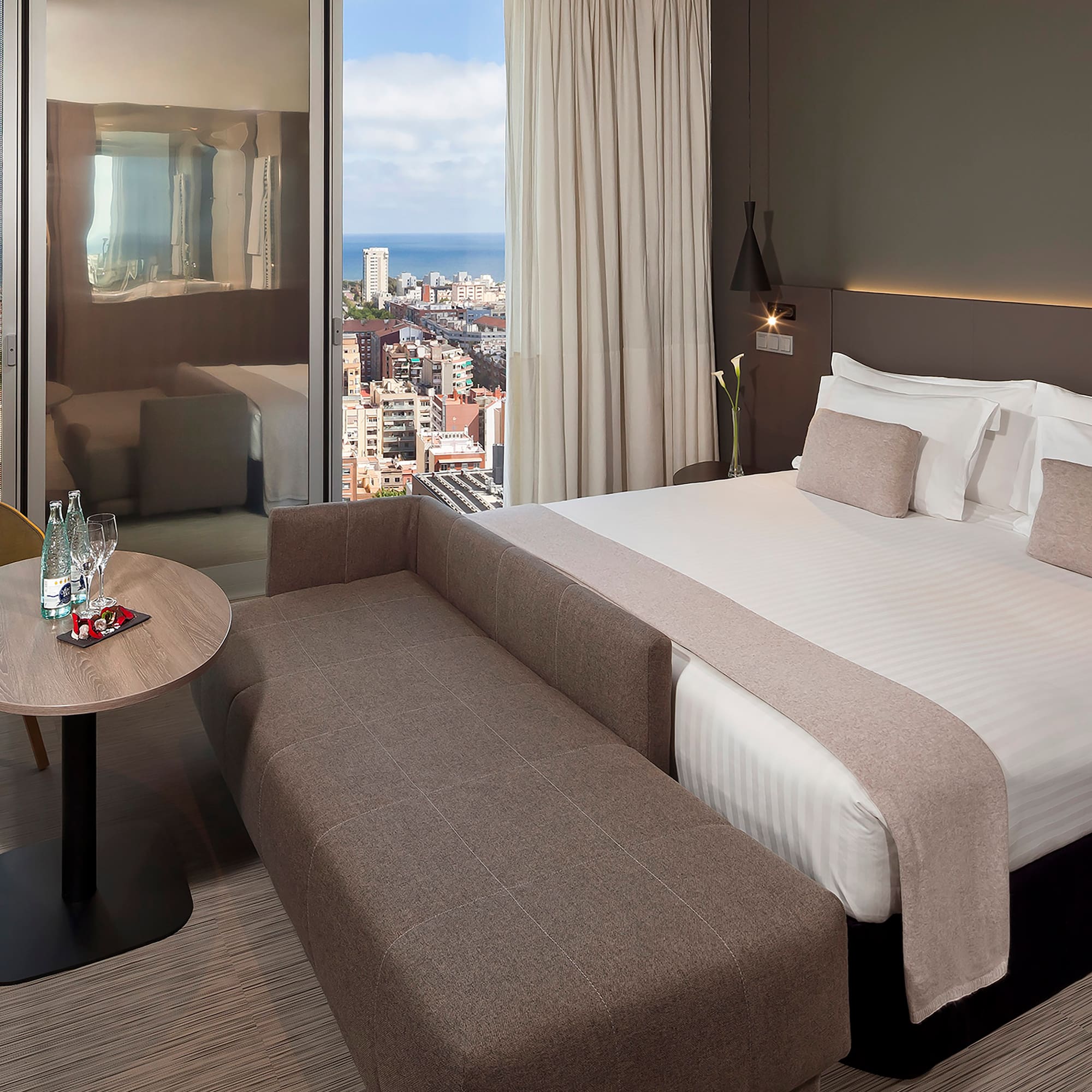 a room with a bed and a table and a window