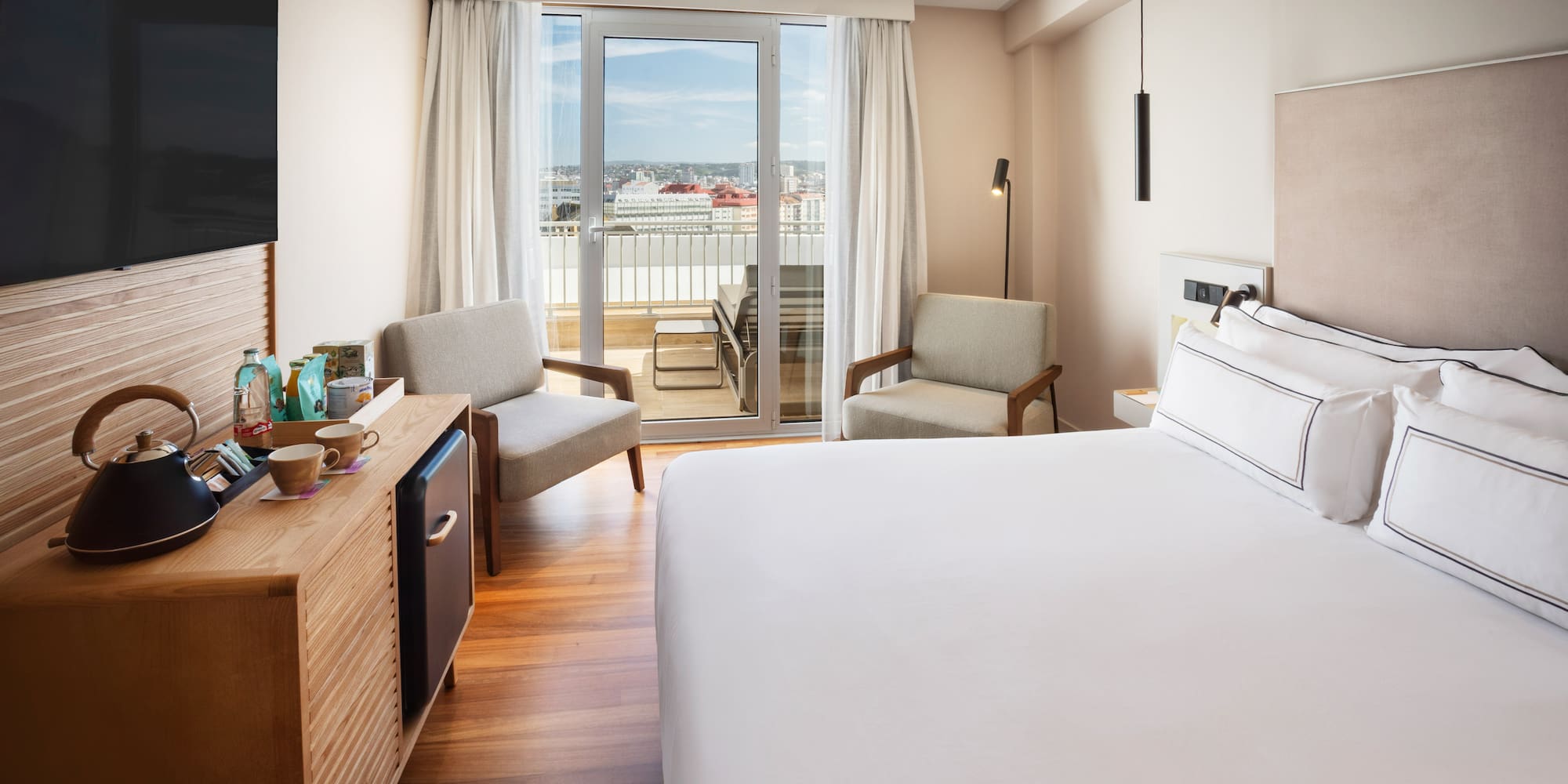 a room with a bed and a television