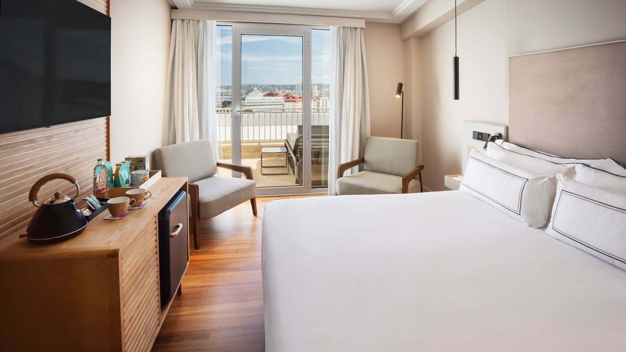 a room with a bed and a television