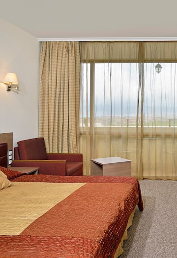 a room with a bed and a chair