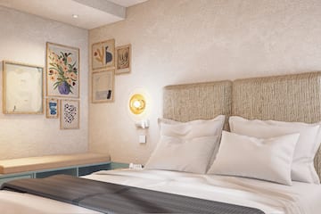 a bed with pillows and a bench in a room