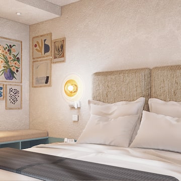 a bed with pillows and a bench in a room