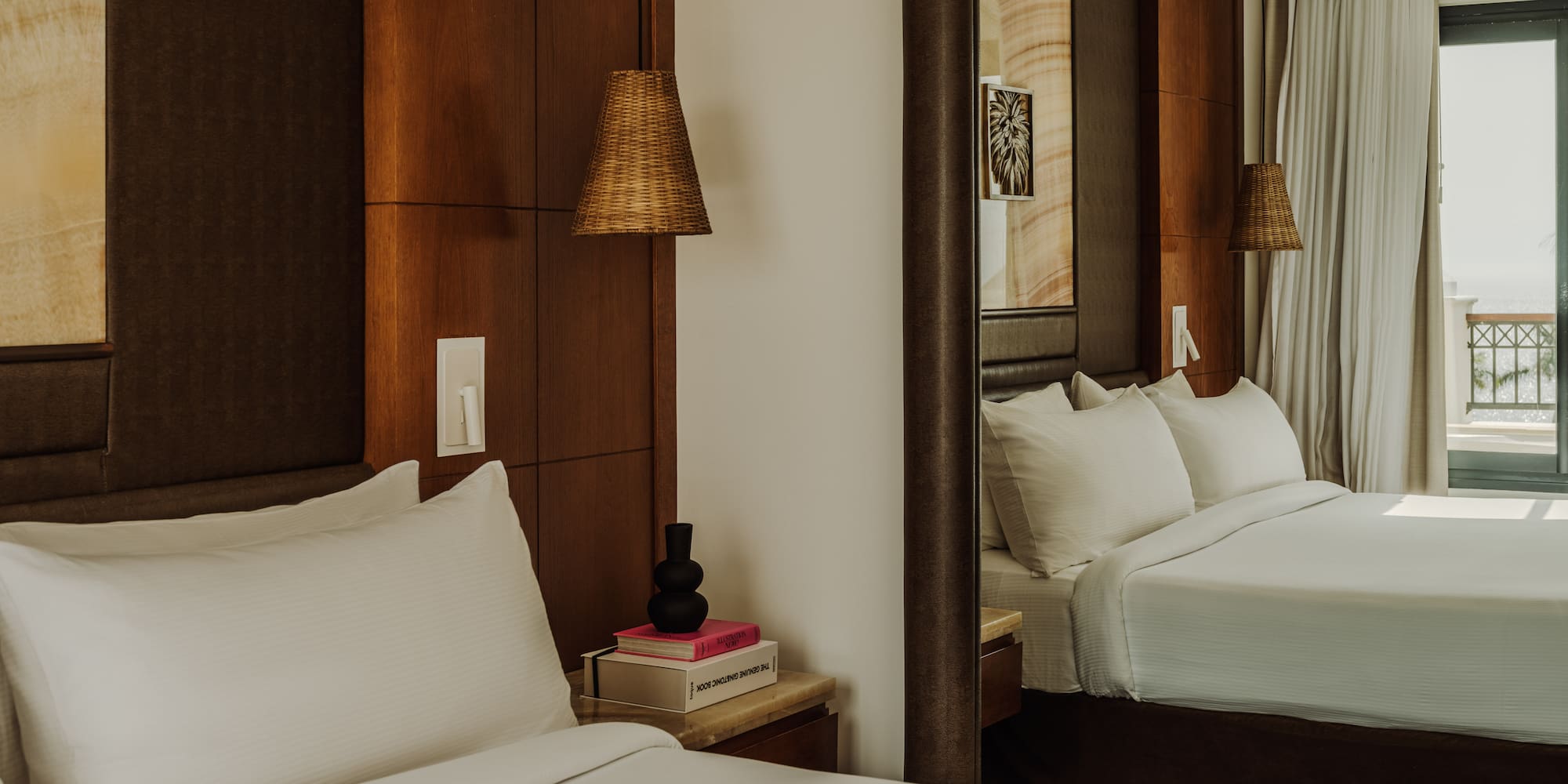 a mirror in a room with a bed and a lamp