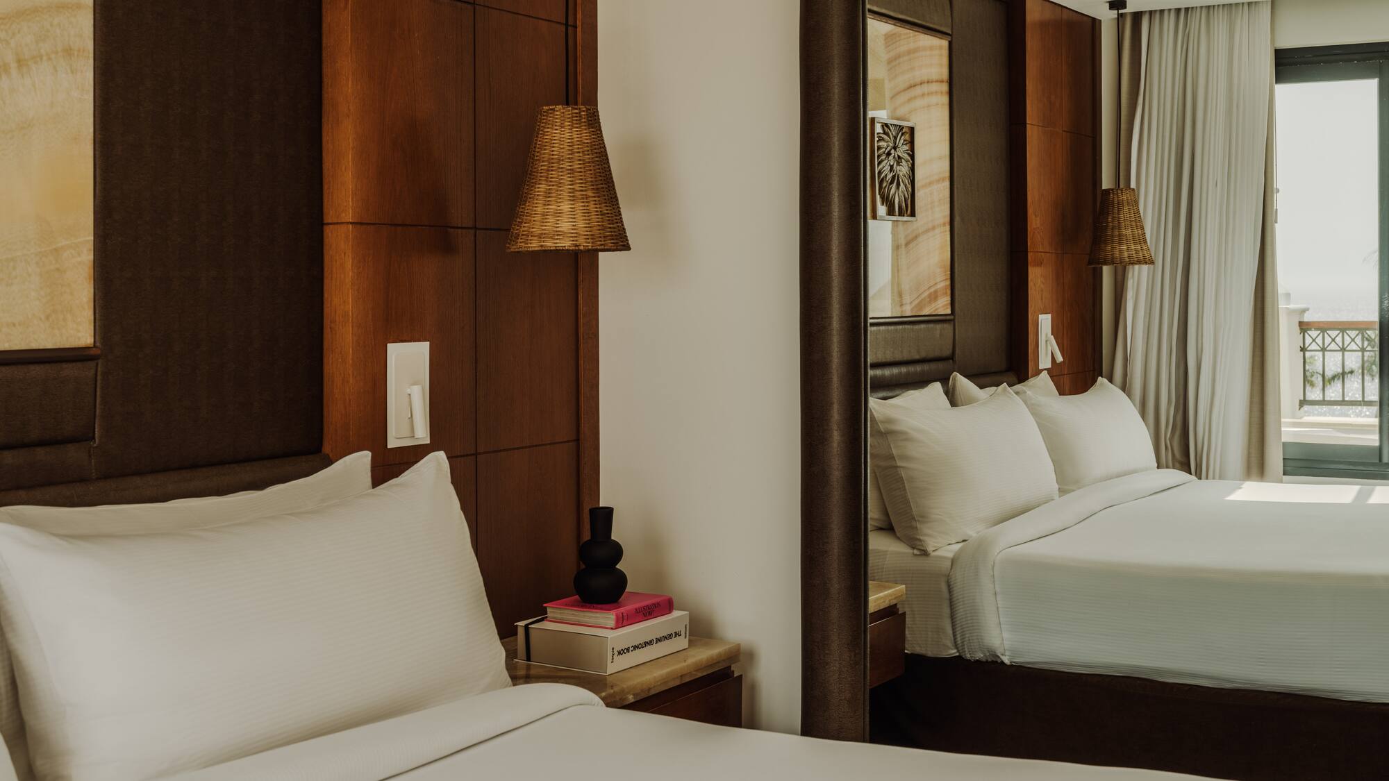 a mirror in a room with a bed and a lamp