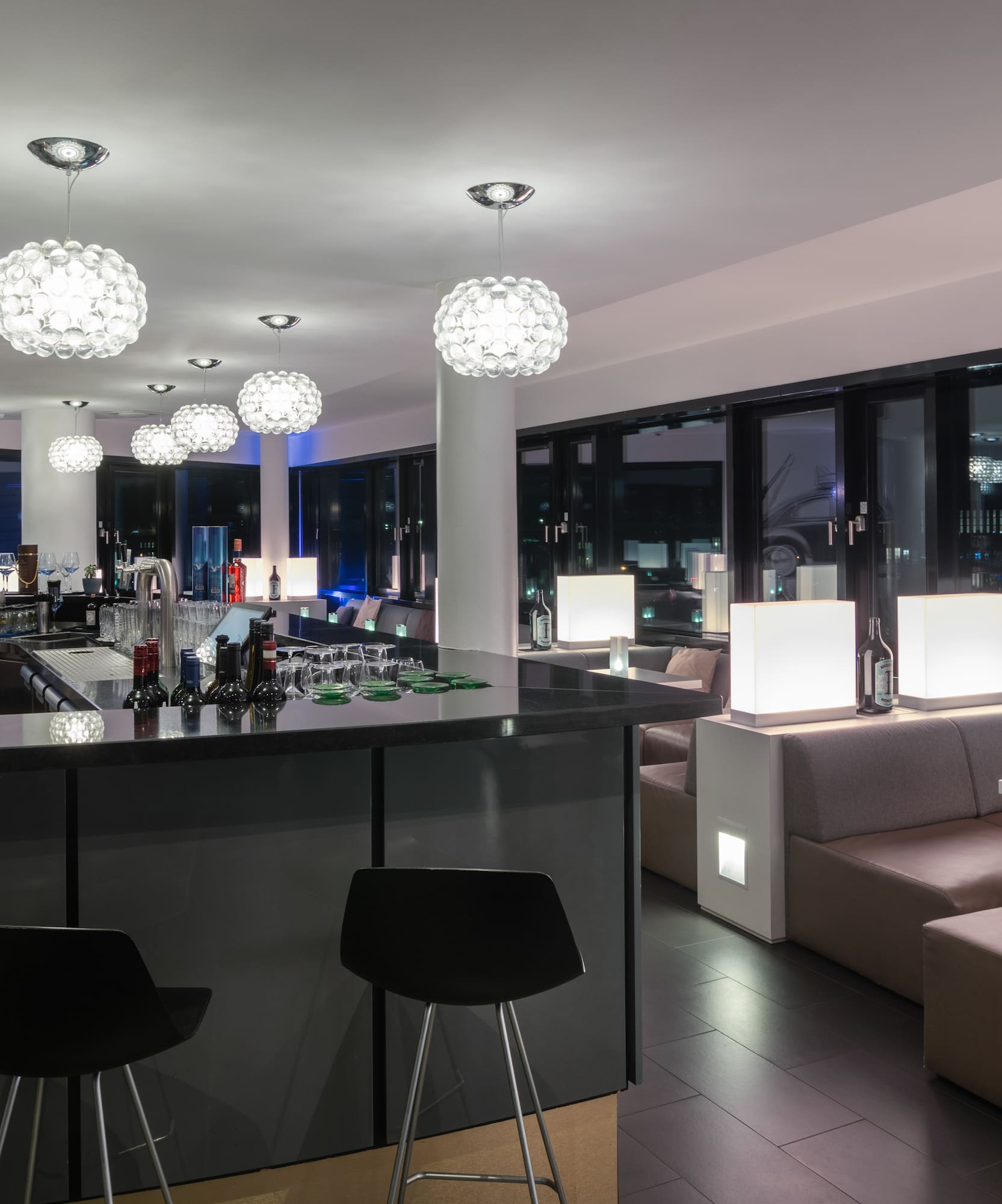 a bar with lights and chairs