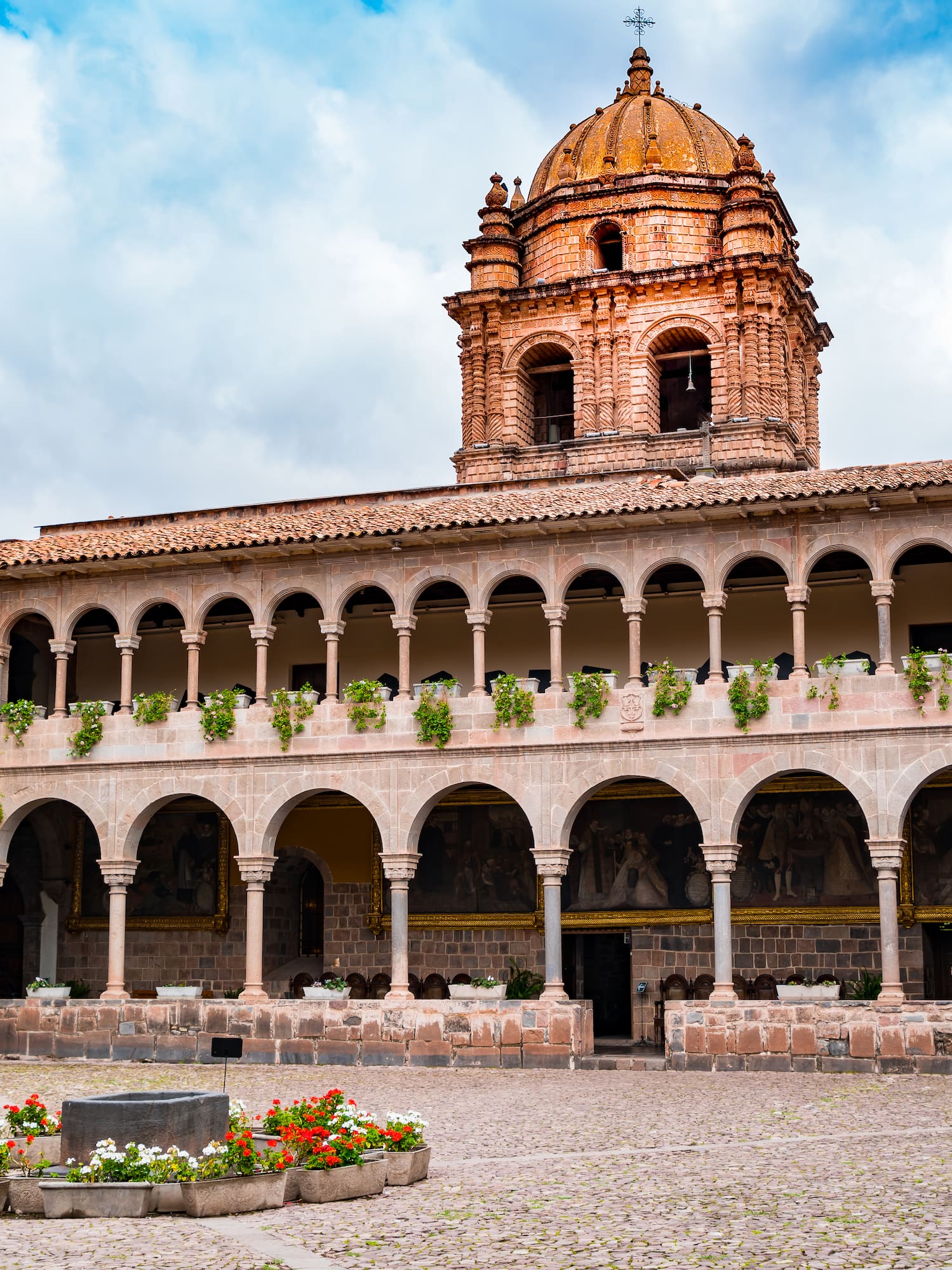 a building with a dome and a stone courtyard
