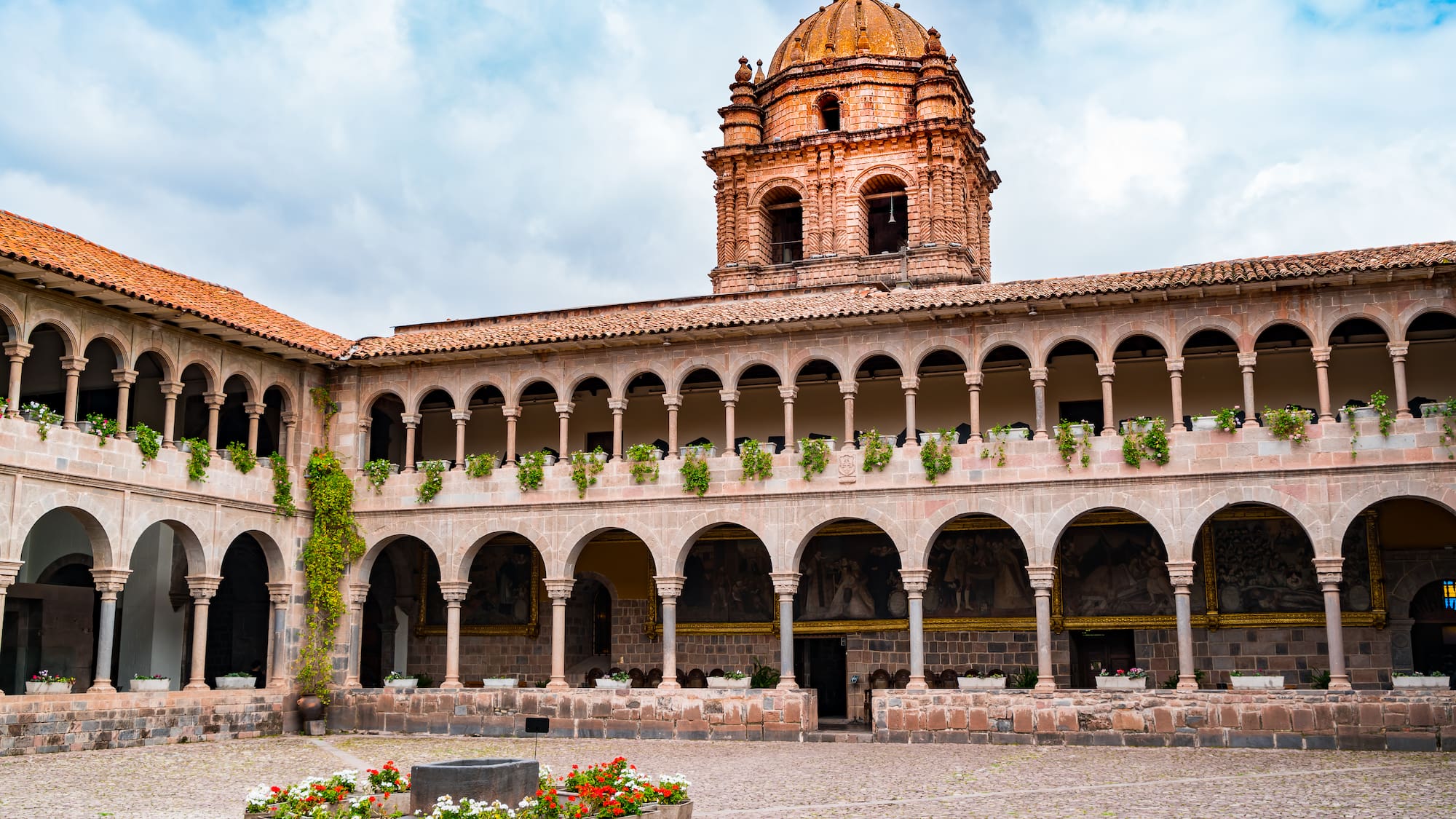 a building with a dome and a stone courtyard