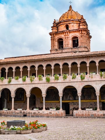 a building with a dome and a stone courtyard