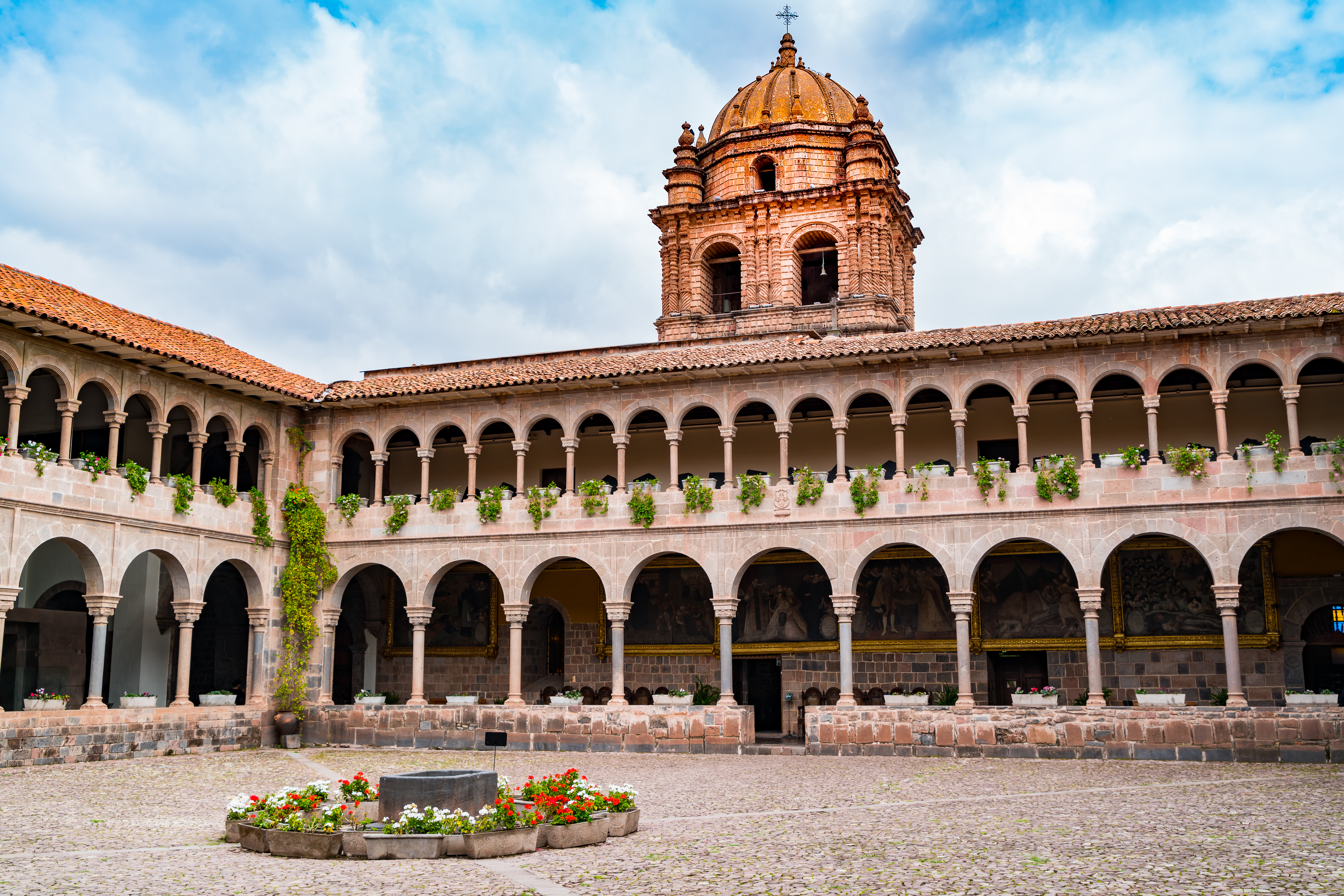 a building with a dome and a stone courtyard