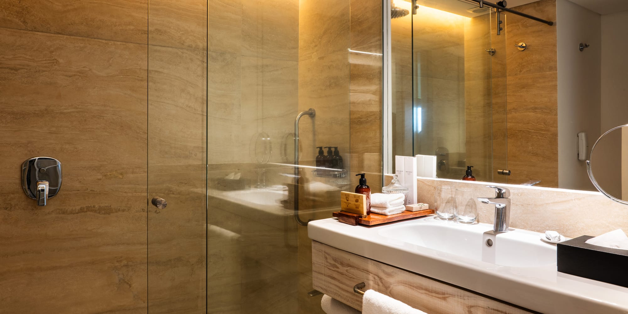 a bathroom with a glass shower and sink