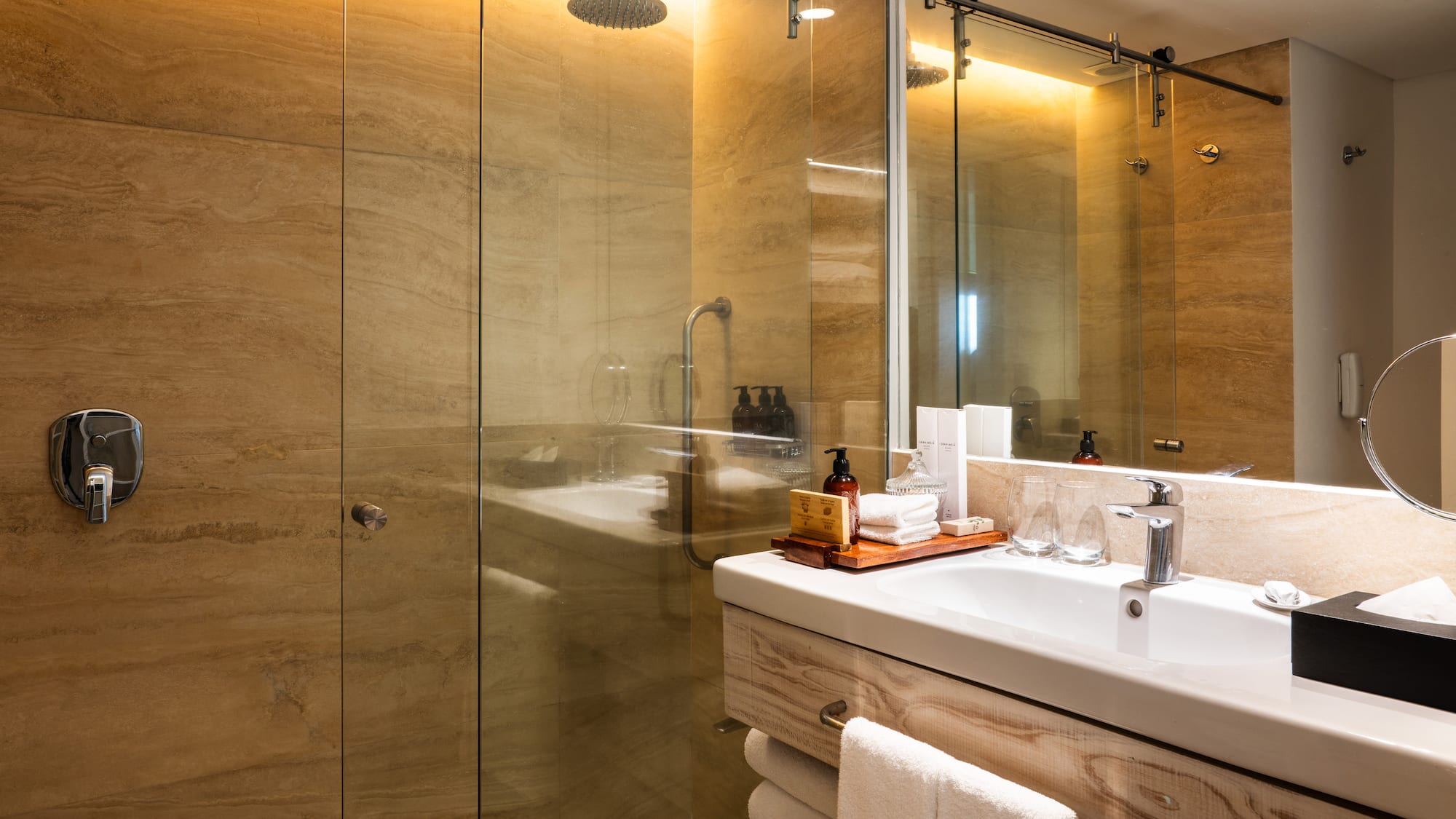 a bathroom with a glass shower and sink