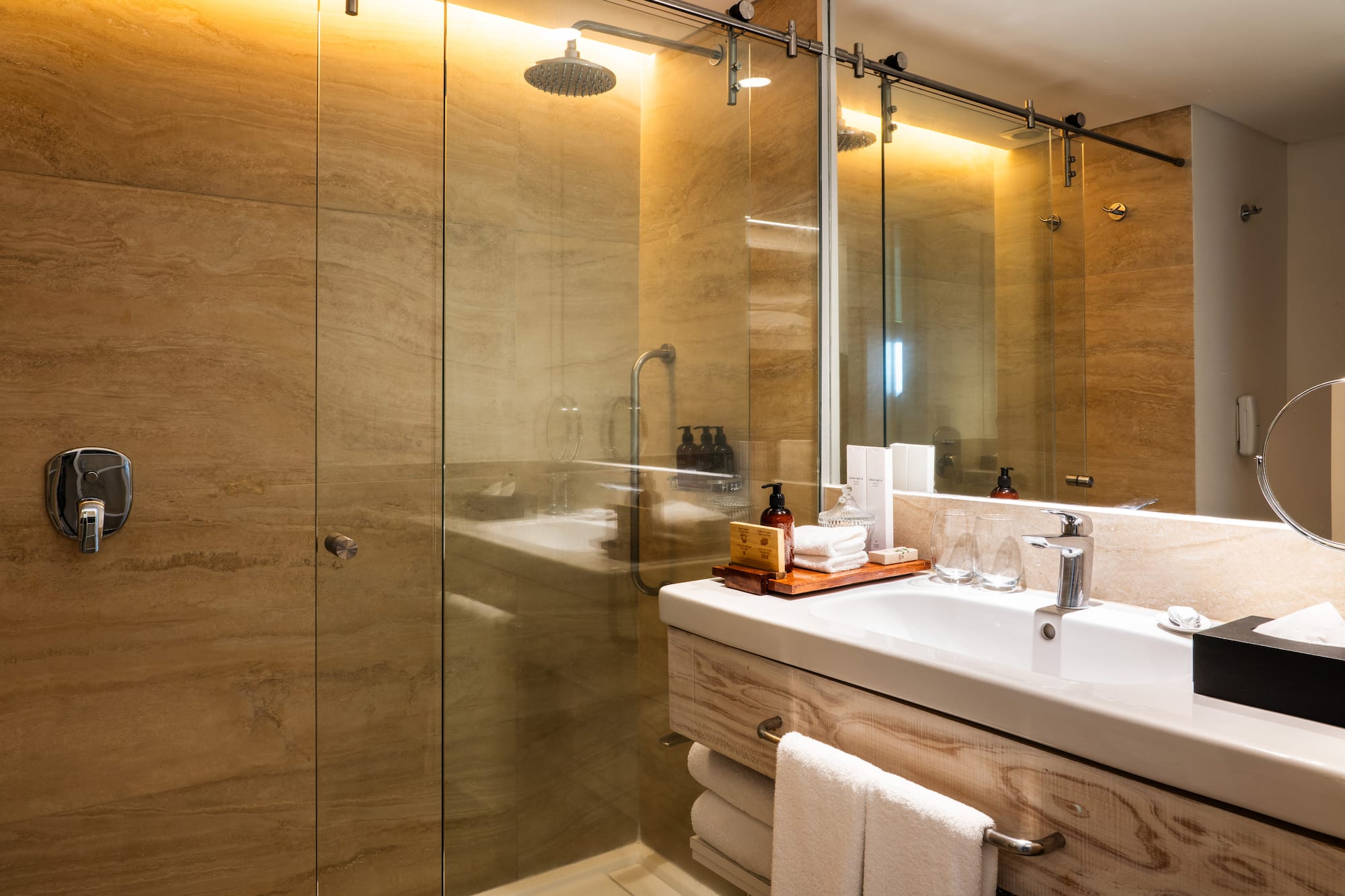 a bathroom with a glass shower and sink